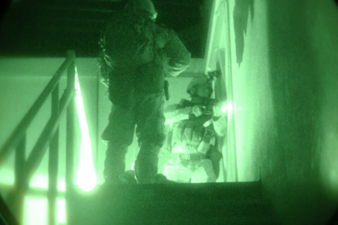 Marines with the Law Enforcement Detachment, 11th Marine Expeditionary Unit, clear a room as part of a simulated long-range raid during Realistic Urban Training Marine Expeditionary Unit Exercise 14-1 (RUTMEUEX) at Fort Hunter Liggett, Calif., March 22, 2014.  RUTMEUEX will prepare the 11th MEU Marines for their upcoming deployment, enhancing their combat skills in environments similar to those they may find in future missions.  (U.S. Marine Corps photo by Lance Cpl. Laura Y. Raga/Released)