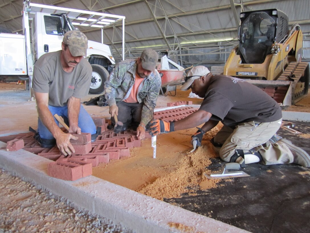 Preparations are made for recent face brick tests at ERDC, part of efforts to find a solution to the often urgent need for low-cost road and airfield infrastructure in theater environments. 