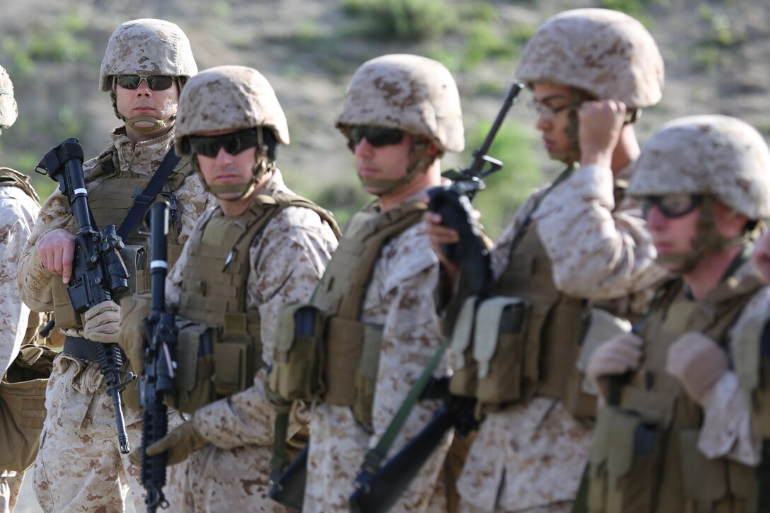 Marines from the 1st Intelligence Battalion stand ready to receive a safety brief before completing their annual rifle qualification aboard Camp Pendleton Calif., March 19.