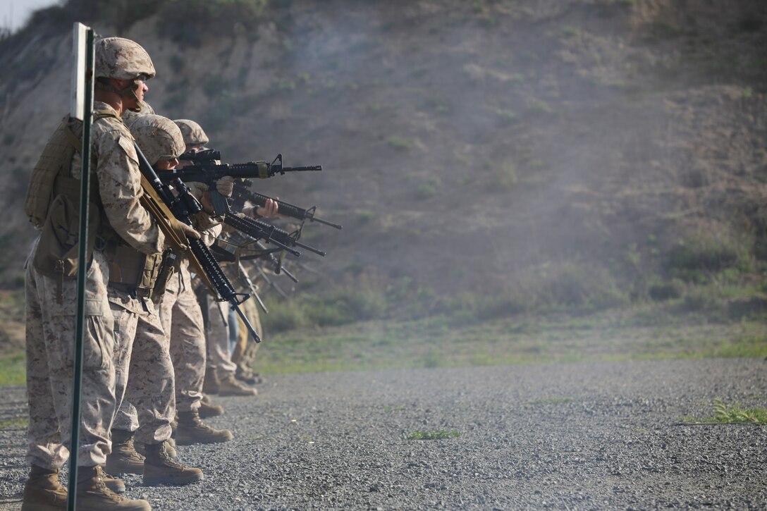 Marines stand at the ready and engage their targets during annual rifle qualification aboard Camp Pendleton Calif., March 19. The training hones the skill of Marines to effectively engage targets in an urban environment.