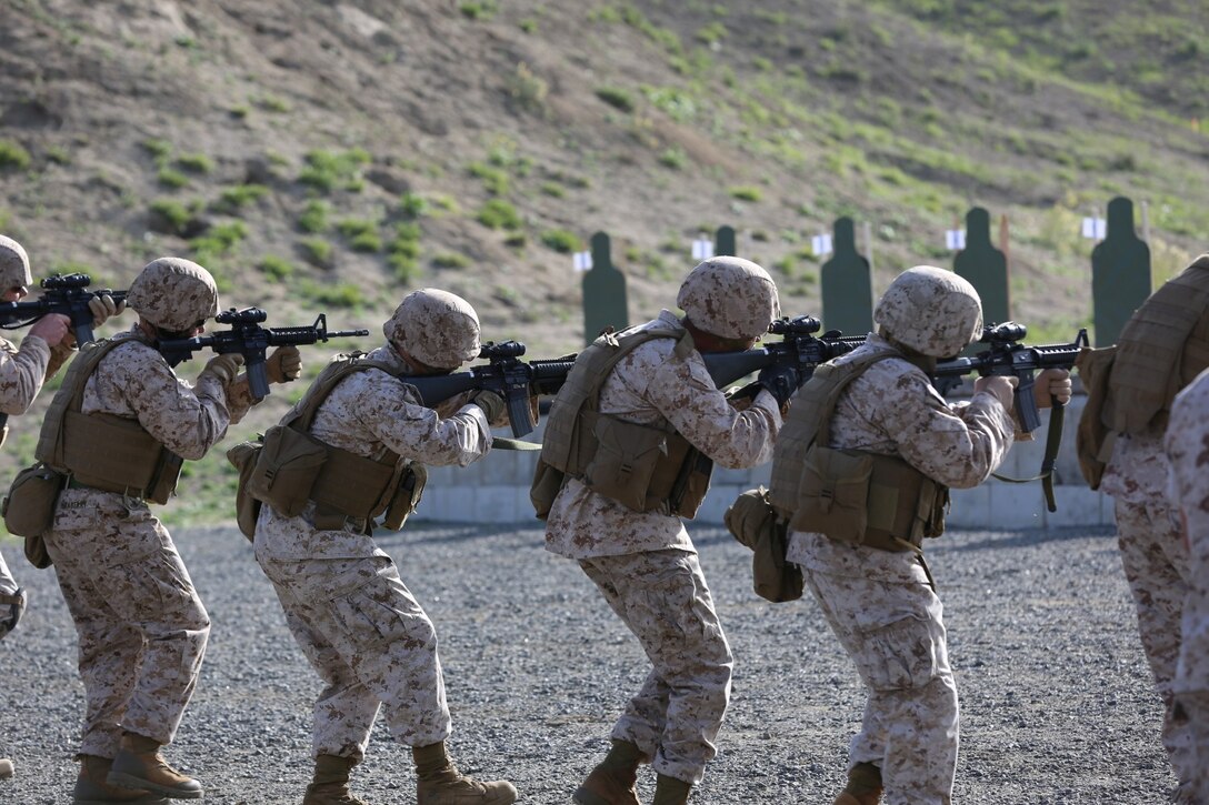 Marines advance and engage their targets during annual rifle qualification aboard Camp Pendleton Calif., March 19.  The training teaches Marines to properly engage and close on enemy targets within an urban environment.