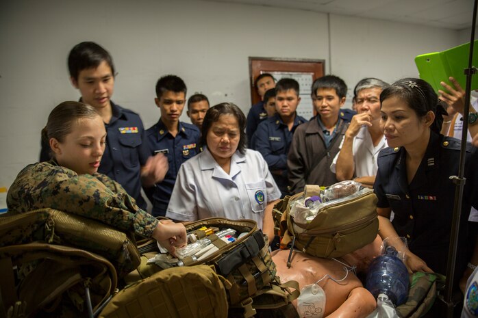 Petty Officer 3rd Class Kelcey Heath shows medical personnel from Wing One hospital supplies found in a medical technician’s pack at the Flight-line Aid Station aboard Wing One Royal Thai Air Force Base, Nakhon Ratchasima, Kingdom of Thailand, Feb. 10 as part of Exercise Cobra Gold 2014. CG 14 is an annual multinational exercise conducted in the Kingdom of Thailand designed to exercise multinational joint interoperability. Heath is a field medical technician with Marine Wing Support Squadron 171, Marine Aircraft Group 12, 1st Marine Air Wing, III Marine Expeditionary Force.