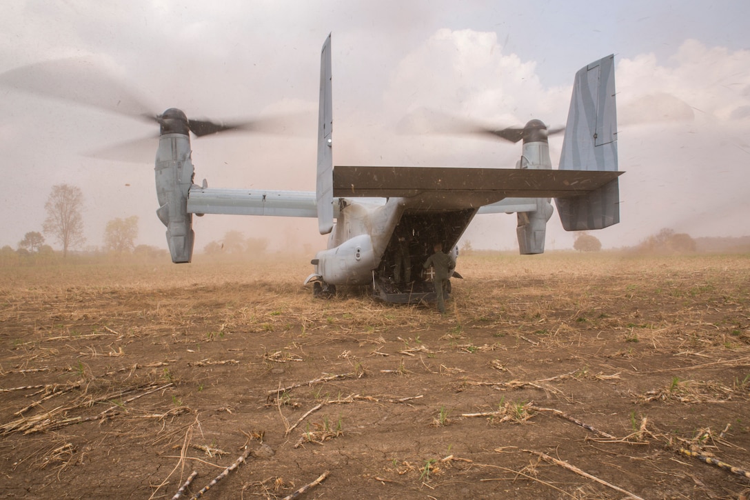 Royal Thai Air Force Flying Officer Satapat Rattana, runs into an MV-22B Osprey during a tactical recovery of aircraft and personnel drill Feb. 13 during Exercise Cobra Gold 2014. CG 14 is a joint, multinational exercise conducted annually in the Kingdom of Thailand aimed at enhancing and increasing combined interoperability. Rattana is a pilot with Squadron 403, Wing 4, Royal Thai Air Force. The MV-22B Osprey is with Marine Medium Tiltrotor Squadron 262, Marine Aircraft Group 36, 1st Marine Aircraft Wing, III Marine Expeditionary Force.