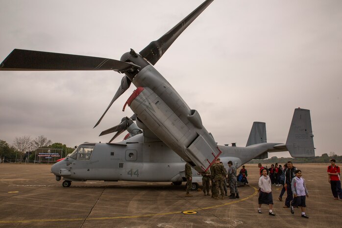 Royal Thai Air Force members and Thai children examine an MV-22B that is part of the static display for a community relations event aboard Wing One Royal Thai Air Force Base, Nakhon Ratchasima, Kingdom of Thailand, Feb. 20 during Exercise Cobra Gold 2014. CG 14 is a joint, multinational exercise conducted annually in the Kingdom of Thailand aimed at enhancing and increasing multinational interoperability. The F-16 is with Squadron 103, Wing One, Royal Thai Air Force. The MV-22B Osprey is with Marine Medium Tiltrotor Squadron 262, Marine Aircraft Group 36, 1st Marine Aircraft Wing, III Marine Expeditionary Force.