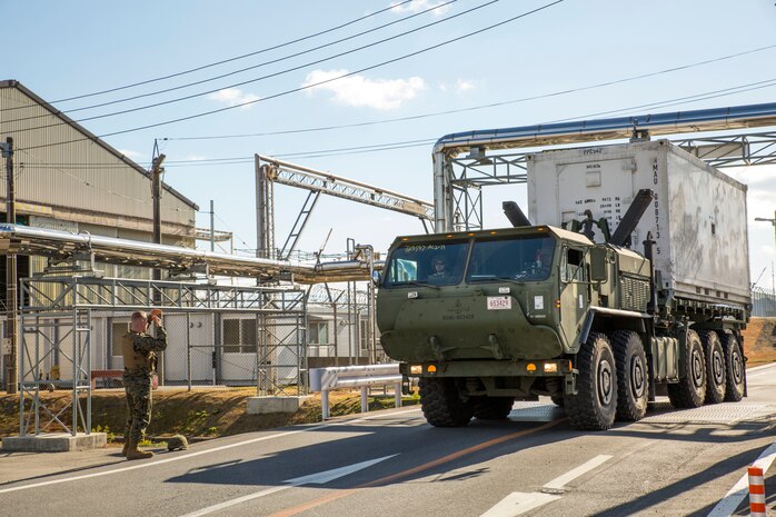 Cpl. Branden Arnett, motor transportation operator with Marine Wing Support Squadron 171, guides a Logistics Vehicle System Replacement MKR-18 Cargo Vehicle through and overpass during the relocation movement of Marine Aviation Logistics Squadron 12 aboard Marine Corps Air Station Iwakuni, Japan, Jan. 15, 2014.
