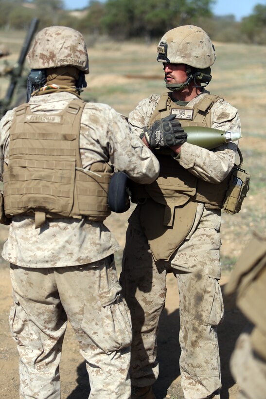 Lance Cpl. Trevor W. Pattillo, right, a field artillery cannoneer with Charlie Battery, Battalion Landing Team 2nd Battalion, 1st Marines (BLT 2/1), 11th Marine Expeditionary Unit, prepares a high-explosive round for an M327 120 mm towed mortar system as part of a fire mission during Realistic Urban Training Marine Expeditionary Unit Exercise (RUTMEUEX) 14-1 at Camp Roberts, Calif., March 23, 2014.  RUTMEUEX will prepare the 11th MEU Marines for their upcoming deployment, enhancing Marines' combat skills in environments similar to those they may find in future missions.  (U.S. Marine Corps photo by Lance Cpl. Evan R. White/Released)