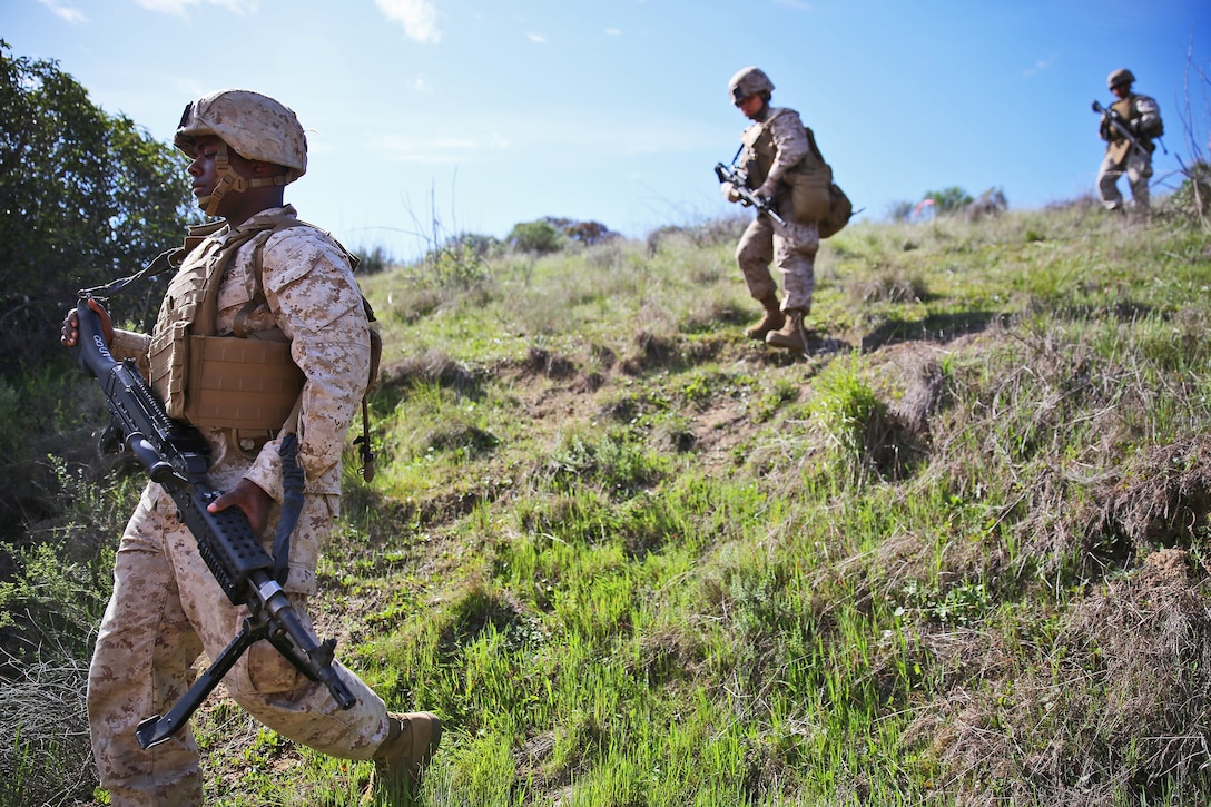 Cpl. Tyrone Stackfield, motor transportation operator, Alpha Company, 7th Engineer Support Battalion, 1st Marine Logistics Group, and his fire team, conduct area and route reconnaissance during the company's super squad competition aboard Camp Pendleton, Calif., March 12, 2014. Eight squads, of approximately 80 Marines and sailors, from Alpha Company participated in the weeklong competition that focused on infantry rifle squad skills, tested small-unit leadership and their combat-readiness. Stackfield, 25, is from Los Angeles. (U.S. Marine Corps photo by Cpl. Timothy Childers / Released)