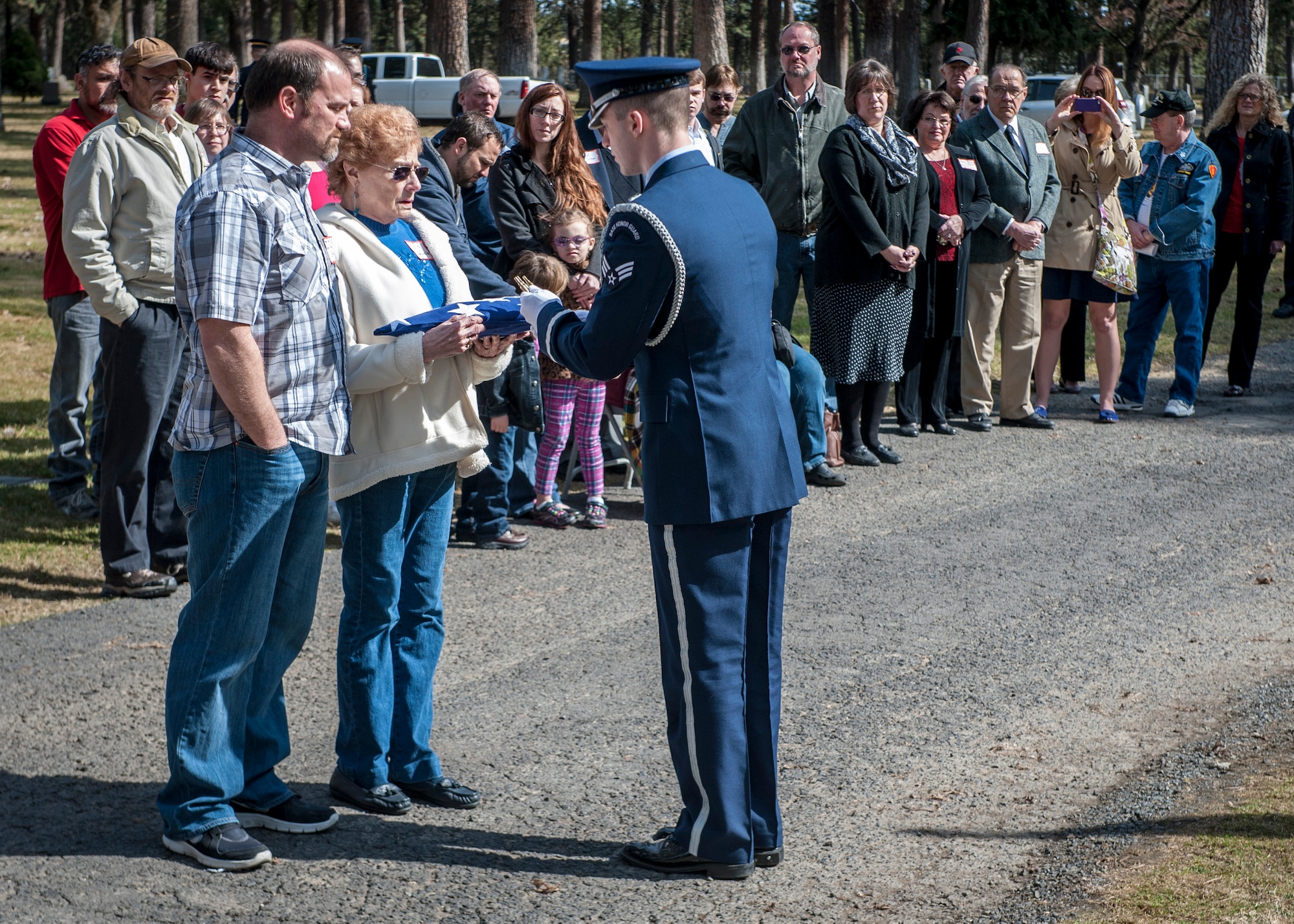 Cpl. Lester Zornes’ flag is presented to his surviving family by a member of the Fairchild Air Force Base Honor Guard during a funeral service in his honor at Fairmount Memorial Park in Spokane, Wash., March 22, 2014. Zornes was flying to England to prepare 82nd Airborne paratroopers for dropping behind enemy lines at Normandy on D-Day. Due to weather instability over the North Atlantic, the aircraft and crew diverted to the alternate route over the South Atlantic when the starboard engine on their C-47 Skytrain gave out crashing and immediately bursting into flames on March 22, 1944. Zornes was 19 with a career in Foreign Service that lasted just 11 days. (U.S. Air Force photo by Staff Sgt. Benjamin W. Stratton/Released)