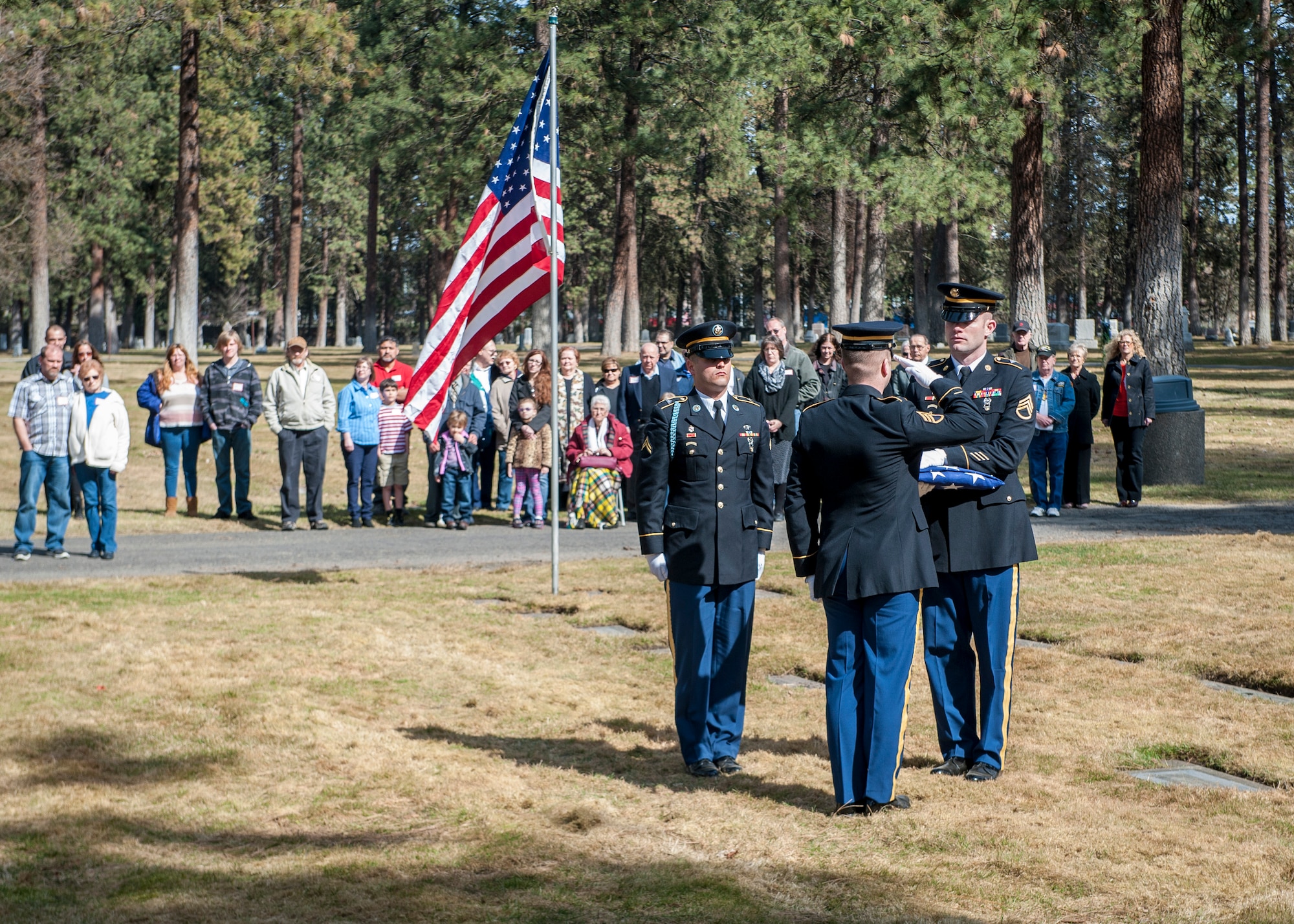Local U.S. Army honor guard members pay respect to the American flag during a funeral service honoring Cpl. Lester Zornes at Fairmount Memorial Park in Spokane, Wash., March 22, 2014. Zornes was flying to England to prepare 82nd Airborne paratroopers for dropping behind enemy lines at Normandy on D-Day. Due to weather instability over the North Atlantic, the aircraft and crew diverted to the alternate route over the South Atlantic when the starboard engine on their C-47 Skytrain gave out crashing and immediately bursting into flames on March 22, 1944. Zornes was 19 with a career in Foreign Service that lasted just 11 days. (U.S. Air Force photo by Staff Sgt. Benjamin W. Stratton/Released)