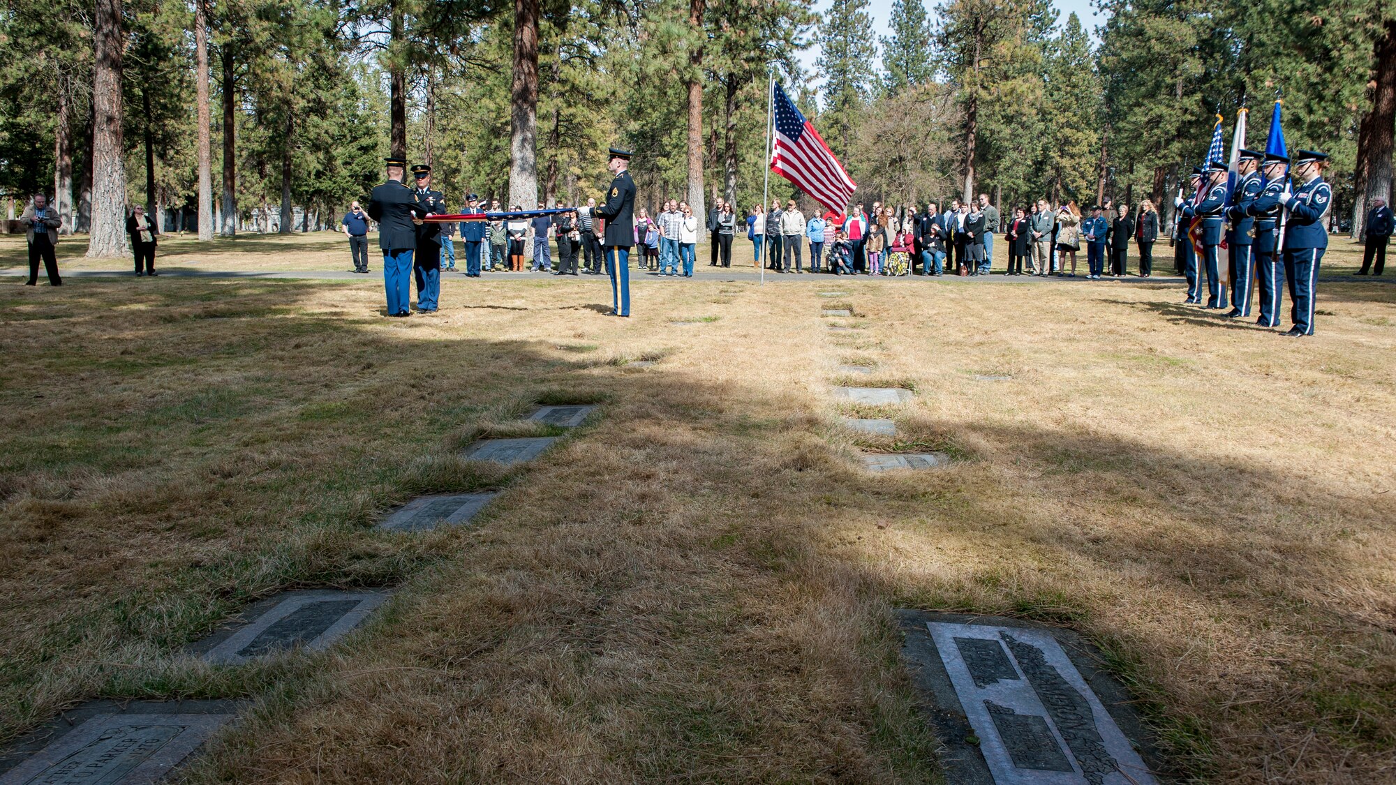 Members of the Fairchild Air Force Base Honor Guard and the U.S. Army perform honor and color guard for a funeral service honoring Cpl. Lester Zornes at Fairmount Memorial Park in Spokane, Wash., March 22, 2014. Zornes was flying to England to prepare 82nd Airborne paratroopers for dropping behind enemy lines at Normandy on D-Day. Due to weather instability over the North Atlantic, the aircraft and crew diverted to the alternate route over the South Atlantic when the starboard engine on their C-47 Skytrain gave out crashing and immediately bursting into flames on March 22, 1944. Zornes was 19 with a career in Foreign Service that lasted just 11 days. (U.S. Air Force photo by Staff Sgt. Benjamin W. Stratton/Released)