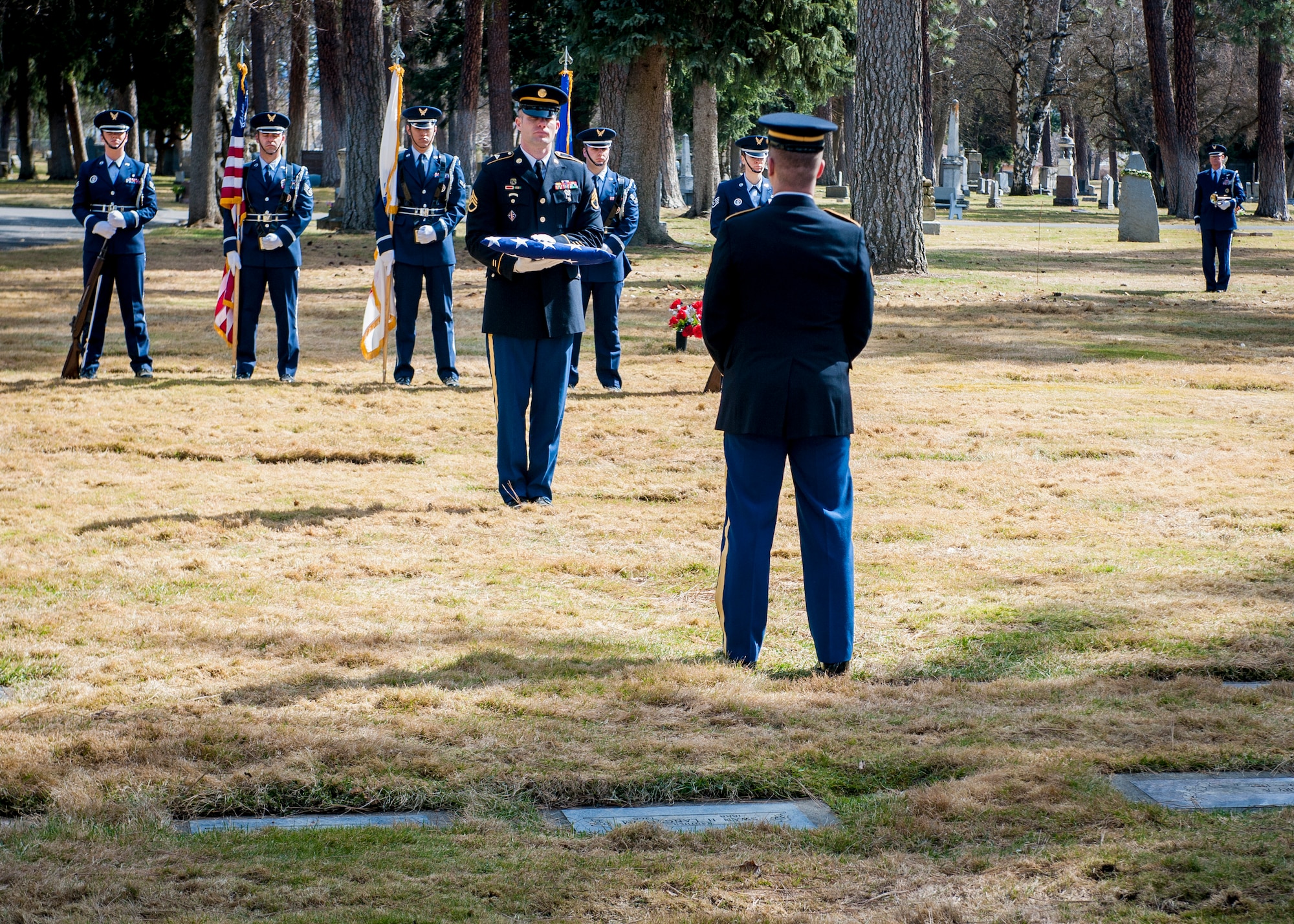 Members of the Fairchild Air Force Base Honor Guard and the U.S. Army perform honor and color guard for a funeral service honoring Cpl. Lester Zornes at Fairmount Memorial Park in Spokane, Wash., March 22, 2014. Zornes was flying to England to prepare 82nd Airborne paratroopers for dropping behind enemy lines at Normandy on D-Day. Due to weather instability over the North Atlantic, the aircraft and crew diverted to the alternate route over the South Atlantic when the starboard engine on their C-47 Skytrain gave out crashing and immediately bursting into flames on March 22, 1944. Zornes was 19 with a career in Foreign Service that lasted just 11 days. (U.S. Air Force photo by Staff Sgt. Benjamin W. Stratton/Released)