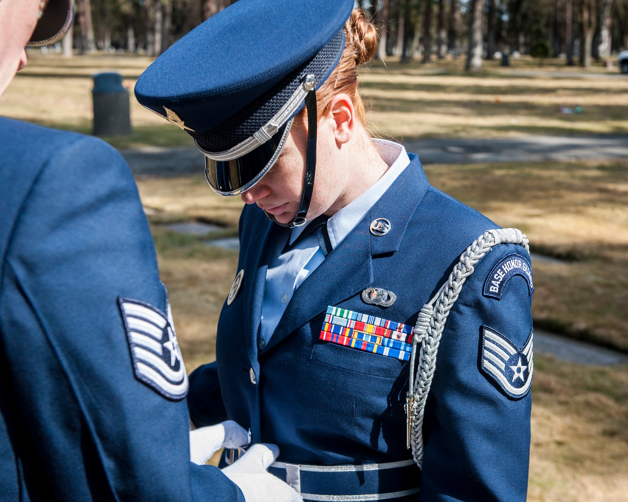 Tech. Sgt. Terrill Castor inspects Staff Sgt. Samantha Krolikowski’s uniform prior to a funeral service honoring Cpl. Lester Zornes at Fairmount Memorial Park in Spokane, Wash., March 22, 2014. The honor guard represents the best of everything the Air Force offers and their uniforms is an important aspect of their service to the base and surrounding communities. Castor and Krolikowski are members of the Fairchild Air Force Base Honor Guard. (U.S. Air Force photo by Staff Sgt. Benjamin W. Stratton/Released)