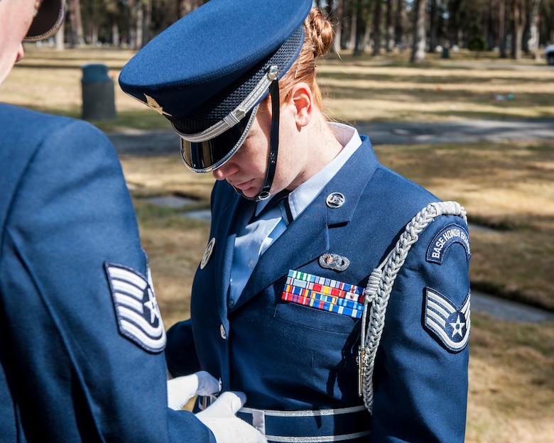 Tech. Sgt. Terrill Castor inspects Staff Sgt. Samantha Krolikowski’s uniform prior to a funeral service honoring Cpl. Lester Zornes at Fairmount Memorial Park in Spokane, Wash., March 22, 2014. The honor guard represents the best of everything the Air Force offers and their uniforms is an important aspect of their service to the base and surrounding communities. Castor and Krolikowski are members of the Fairchild Air Force Base Honor Guard. (U.S. Air Force photo by Staff Sgt. Benjamin W. Stratton/Released)