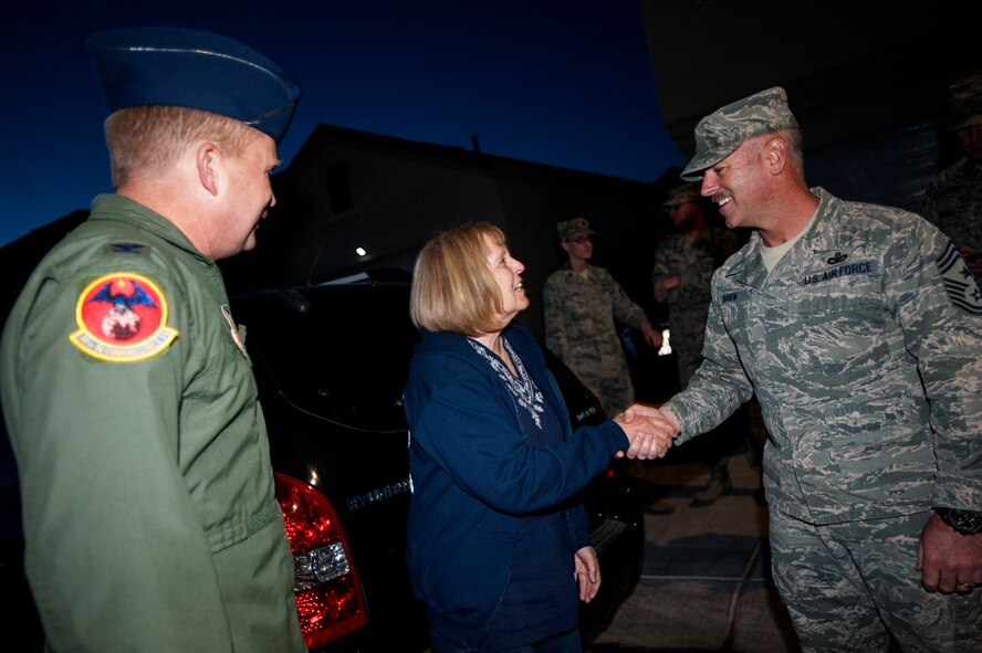 Chief Master Sgt. Butch Brien, right, 432nd Wing/432nd Air Expeditionary Wing command chief, and Col. James Cluff, 432nd Wing/432nd AEW commander congratulate family members of Master Sgt. Dawn, 432nd Operations Support Squadron during a surprise senior master sergeant selectee notification visit. Dawn’s family was ecstatic to be a part of this experience since she recently arrived to Creech Air Force Base, Nev. (U.S. Air Force photo by Senior Master Sgt. C.R.)