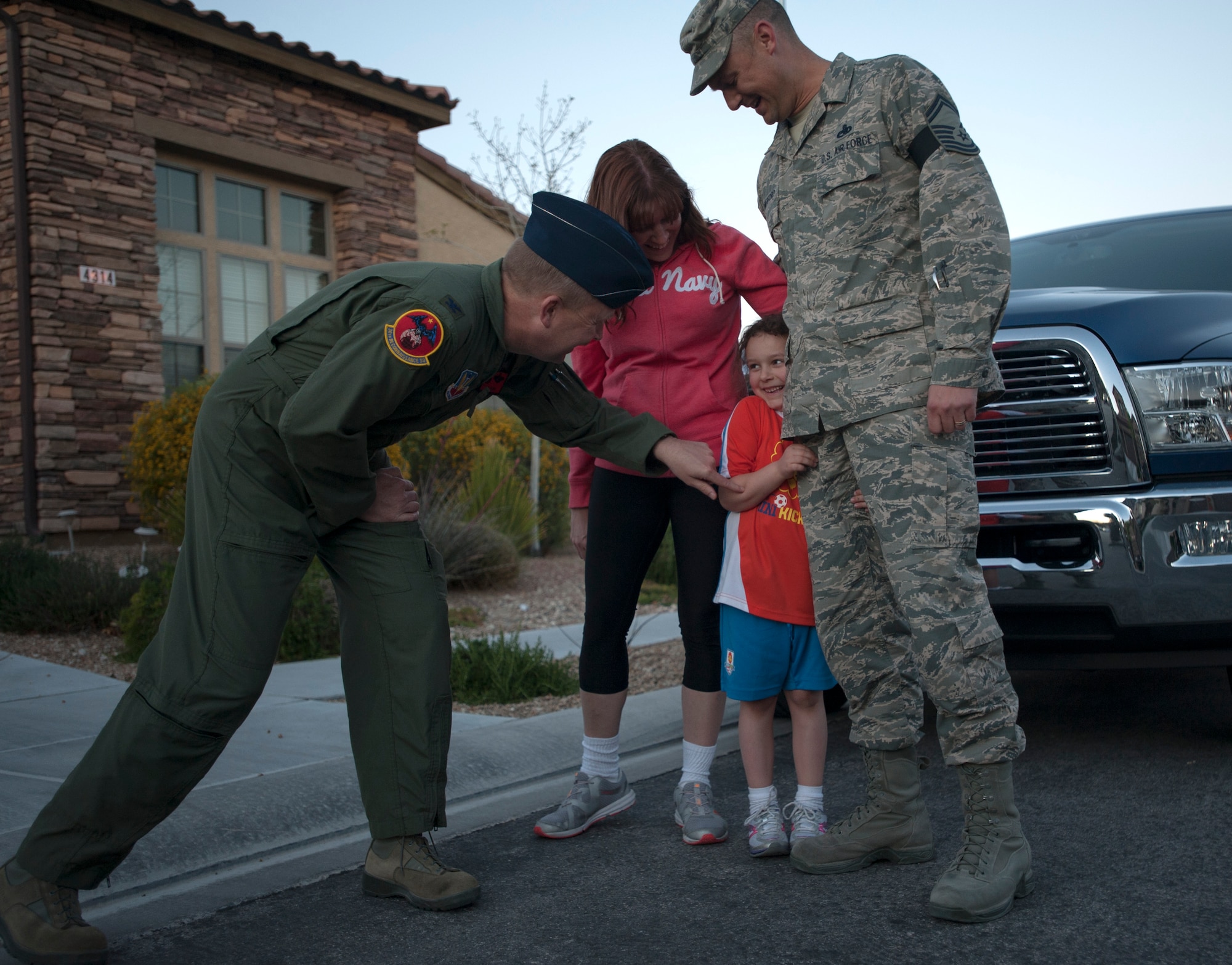 Col. James Cluff, 432nd Wing/432nd Air Expeditionary Wing commander, personally congratulates Master Sgt. Gordon, 432nd Maintenance Squadron accountable munitions systems officer, and his family on his selection to senior master sergeant. Leadership from the 432nd Wing/432nd Air Expeditionary Wing made sure that Creech Air Force Base’s newest senior master sergeants and their families were personally recognized for their achievements with an unexpected visit at their home.  (U.S. Air Force photo by Senior Master Sgt. C.R.)