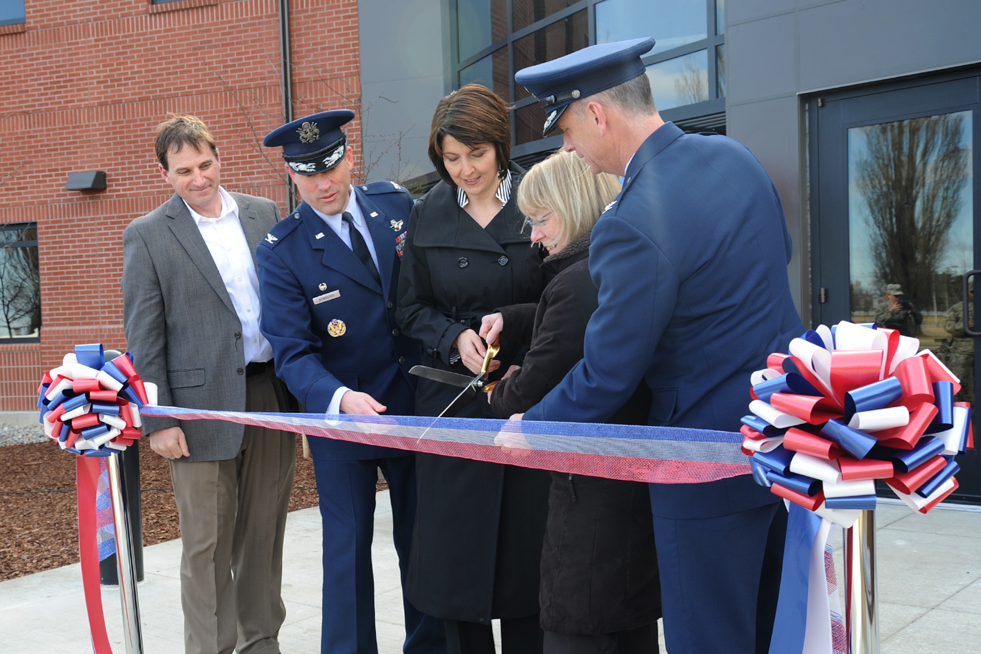 Doug Jackson, Jackson Construction Group president, Col. Brian Newberry, the 92nd Air Refueling Wing commander, U.S. Rep. Cathy McMorris Rodgers, U.S. Sen. Patty Murray and Col. Daniel Swain, the 141st ARW commander, cut the ribbon during the opening of the new headquarters building at Fairchild Air Force Base, Wash., March 20, 2014. The building is designed for both the 92nd and 141st Air Refueling Wings. (U.S. Air Force photo by Airman 1st Class Janelle Patiño/Released)