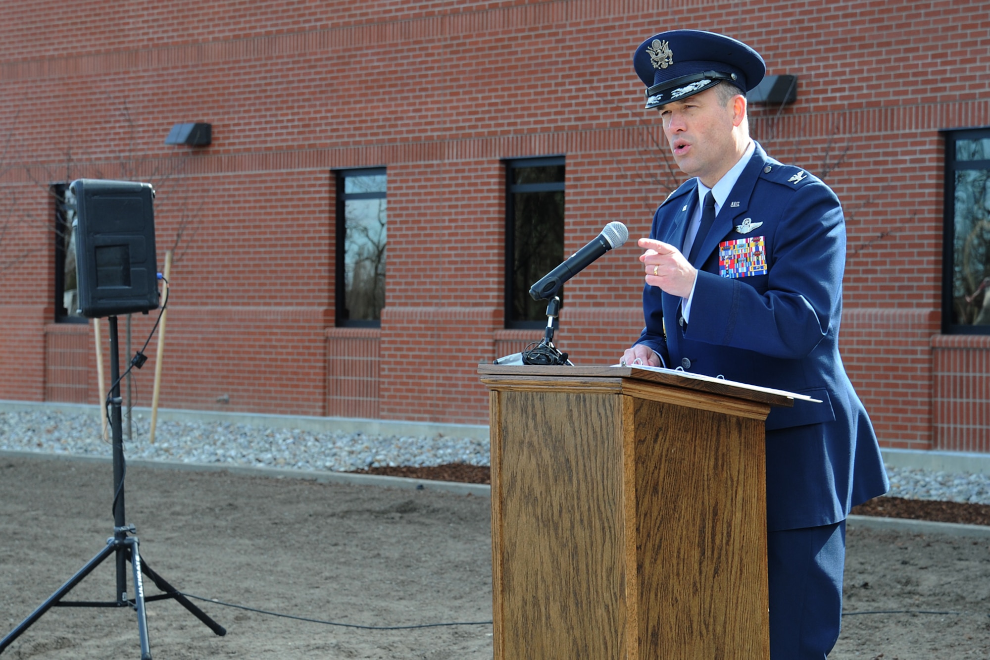 Col. Brian Newberry, 92nd Air Refueling Wing commander, thanks the people invovled in making the new headquarters happen during the ribbon cutting ceremony at Fairchild Air Force Base, Wash., March 20, 2014. The ribbon cutting signifies the opening of a new chapter for generations of Airmen to come. (U.S. Air Force photo by Airman 1st Class Janelle Patiño/Released)