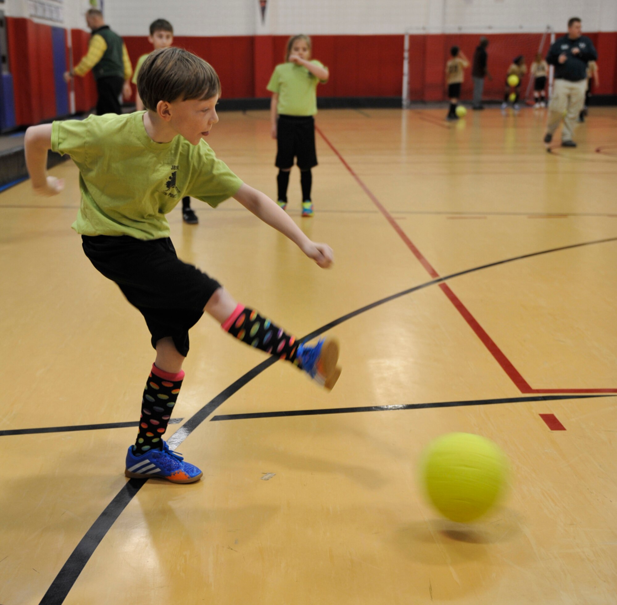 Ethan Eggie, 10, son of Army Staff Sgt. Shaun Eggie, 545th Military Police Company, and member of the Green Dragons youth soccer team, kicks a ball during practice before a game at the Kennecott Youth Center on Joint Base Elmendorf-Richardson, Alaska, March 17, 2014. Each team plays 13 games each season and tournament games begin in April. (U.S. Air Force photo/Airman 1st Class Tammie Ramsouer)