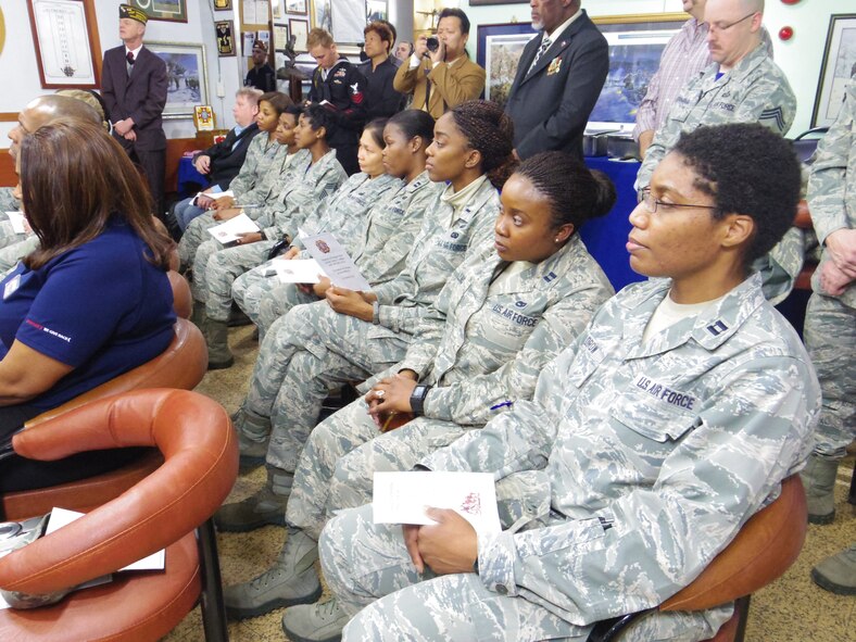 Members of Osan Air Base listen to keynote speaker, Rear Adm. Lisa M. Franchetti, commander of Naval Forces Korea, during a ceremonial dedication to women in the military March 21 at the Veterans of Foreign Wars Post 10216 in Songtan, Republic of Korea. VFW Post 10216 provided the means for Osan members to dedicate a wall to women in the service as part of Women's History Month. (U.S. Air Force photo / 1st Lt. Kay M. Nissen)