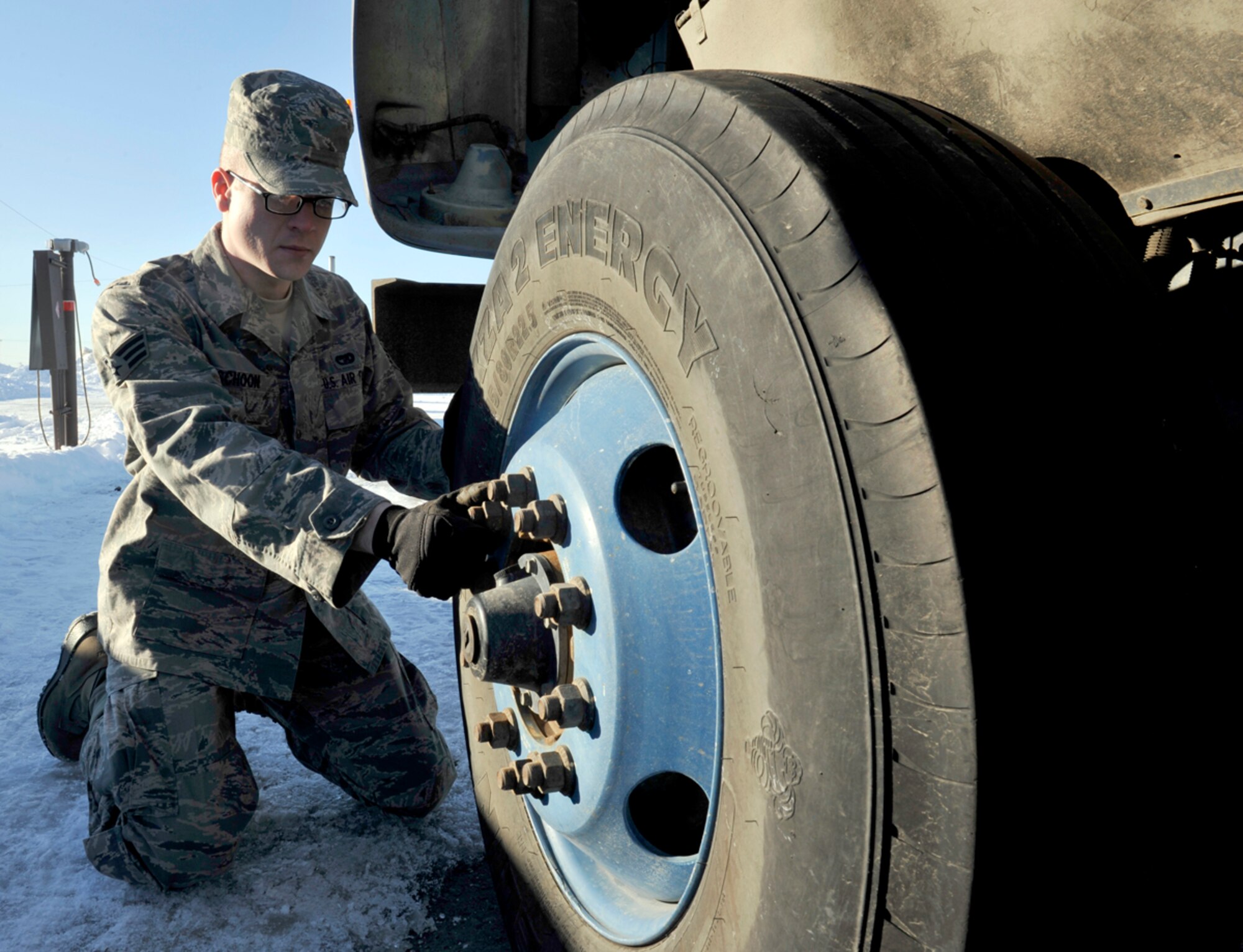 Senior Airman Andrew Schoon, 773d Logistics Readiness Squadron vehicle operator/dispatcher, checks lug nuts on a seven-and-a-half-ton tractor on Joint Base Elmendorf-Richardson, Alaska, March 20, 2014. Schoon earned a spot in this year’s Tops in Blue  tour as a crew worker. Tops in Blue has recruited performers and staff for more than 60 years. (U.S. Air Force photo/Airman 1st Class Tammie Ramsouer)