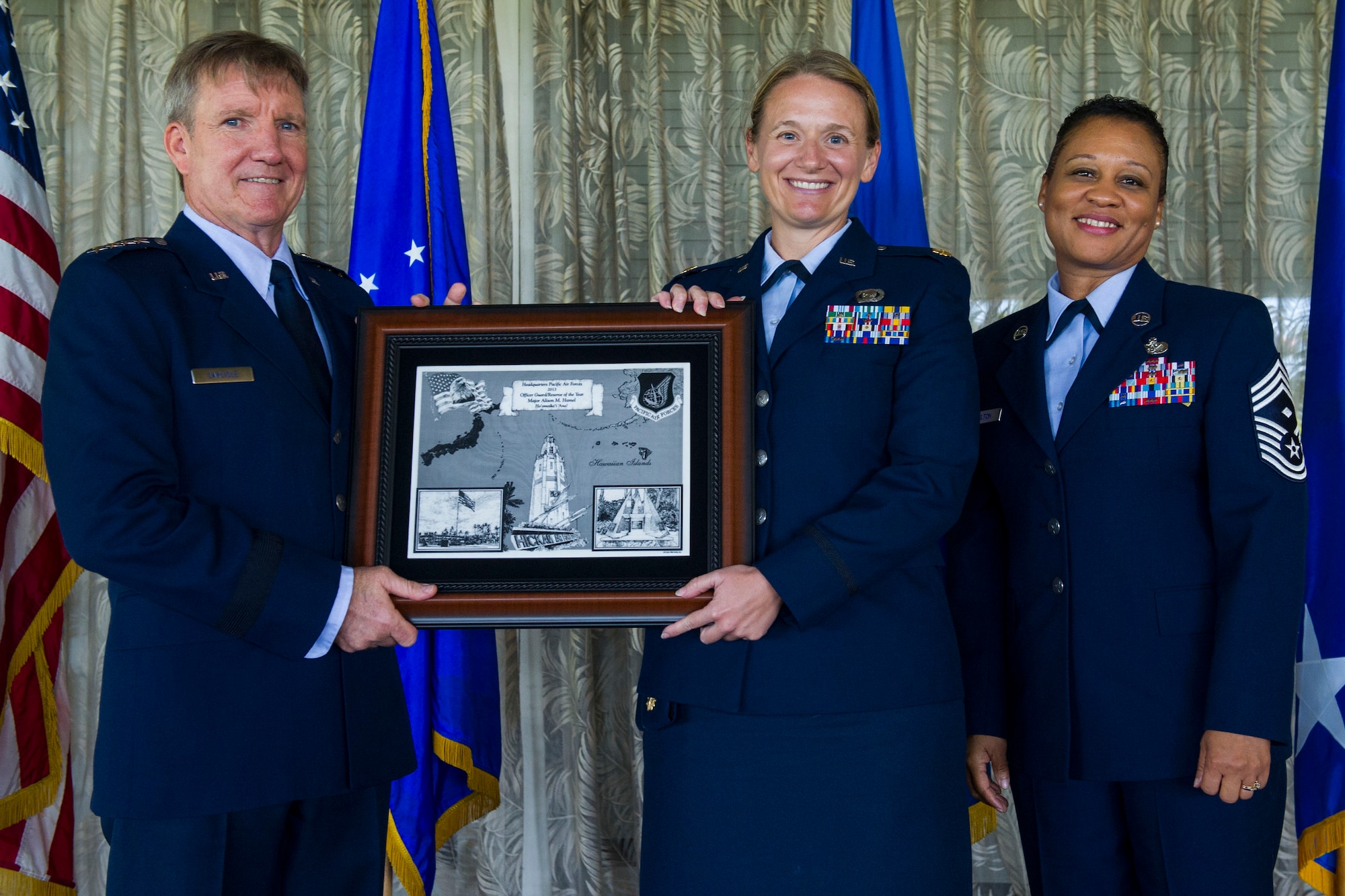 (Left) Gen. Hawk Carlisle, Pacific Air Forces commander, and (right) Chief Master Sgt. Rita Felton, Headquarters PACAF First Sgt., present the 2013 Headquarters PACAF Reserve/Guard Officer of the Year award to Maj. Alison Hamel, 713th Combat Operations Squadron A2 Intelligence officer at the 2013 PACAF Annual Awards banquet Feb. 25, 2014. Hamel was also named the 2013 PACAF/A2 Air Force Intelligence, Surveillance & Reconnaissance Awards Program Reserve Officer of the Year.