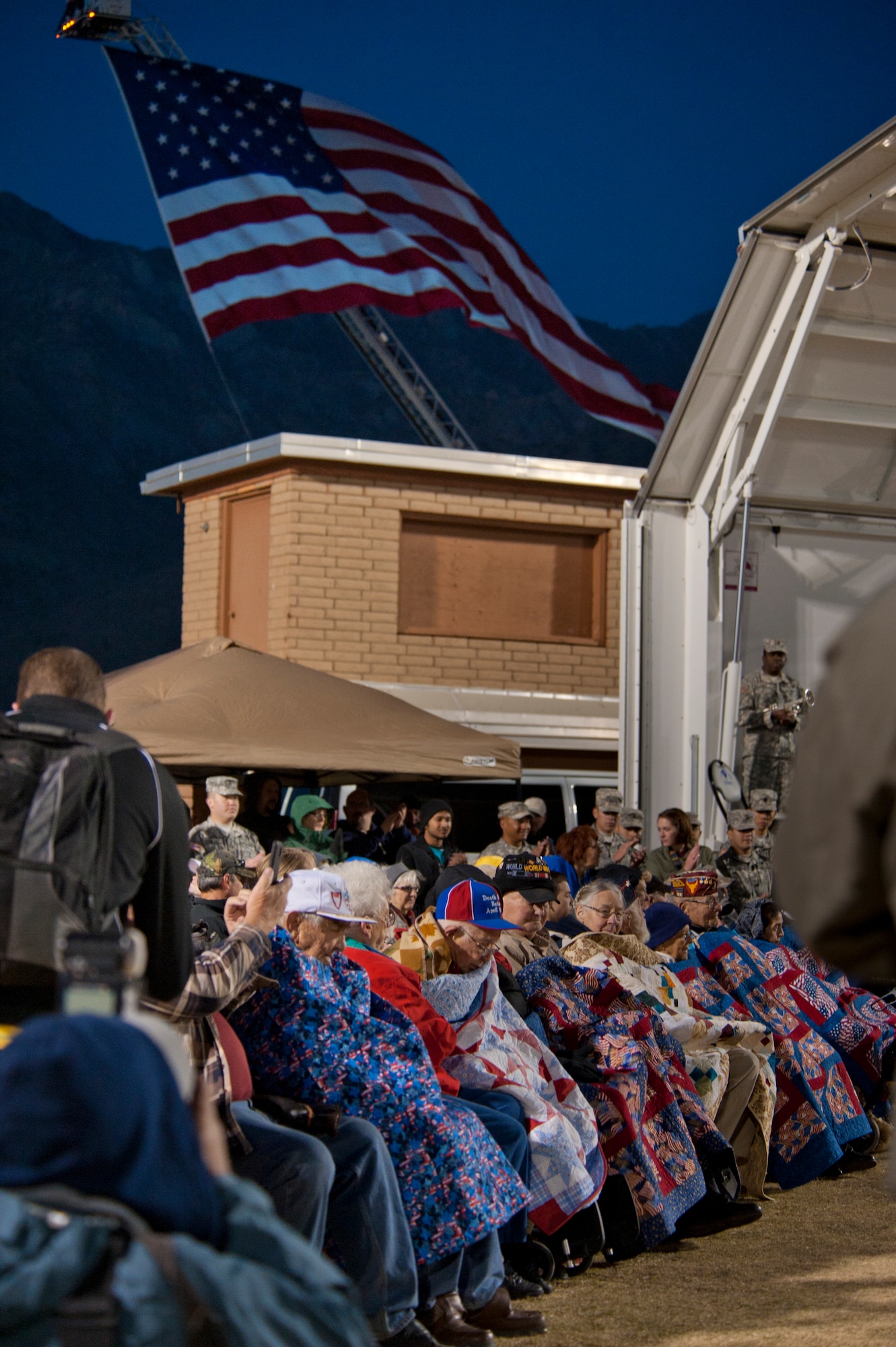 Survivors of the Bataan Death March wait to be introduced during the opening ceremony of the Bataan Memorial Death March at White Sands Missile Range, N.M., March 23. Over 6,200 participants came to honor more than 76,000 Prisoners of War and Missing in Action from Bataan and Corregidor during World War II. The 26.2-mile course starts on WSMR, enters hilly terrain and finishes through sandy desert trails, with elevation ranging from 4,100 to 5,300 feet. (U.S. Air Force photo by Airman 1st Class Aaron Montoya / Released)