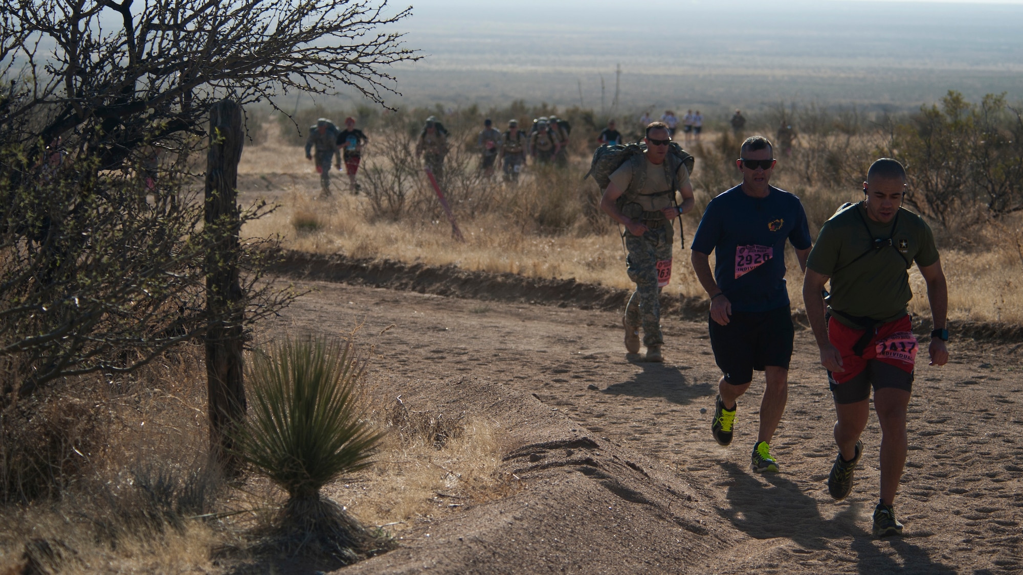 Participants in the 25th annual Bataan Memorial Death March make their way through the course at White Sands Missile Range, N.M., March 23. Over 6,200 participants came to honor more than 76,000 Prisoners of War and Missing in Action from Bataan and Corregidor during World War II. The 26.2-mile course starts on WSMR, enters hilly terrain and finishes through sandy desert trails, with elevation ranging from 4,100 to 5,300 feet. (U.S. Air Force photo by Airman 1st Class Aaron Montoya / Released)