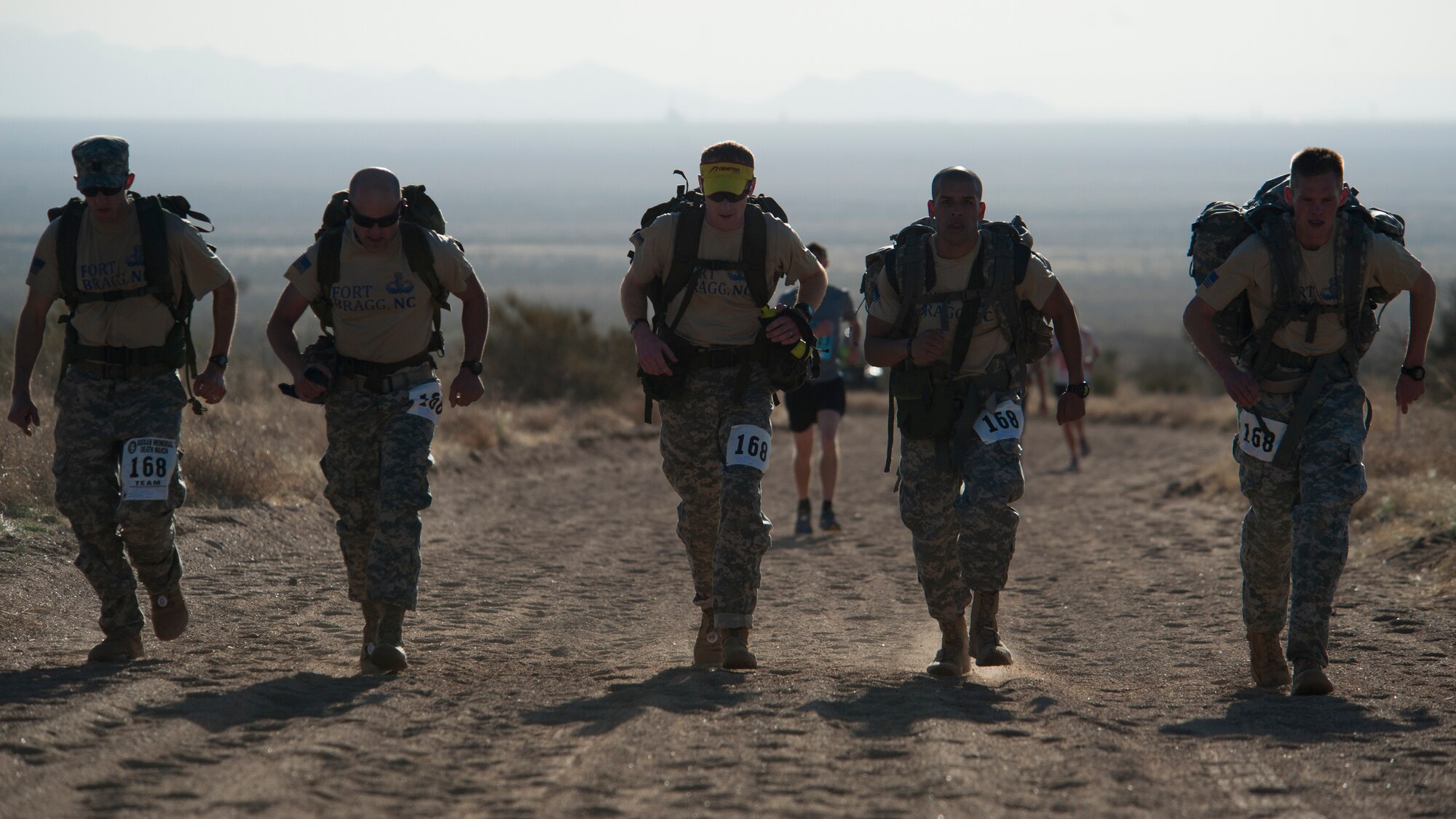 Participants in the 25th annual Bataan Memorial Death March make their way through the course at White Sands Missile Range, N.M., March 23. Over 6,200 participants came to honor more than 76,000 Prisoners of War and Missing in Action from Bataan and Corregidor during World War II. The 26.2-mile course starts on WSMR, enters hilly terrain and finishes through sandy desert trails, with elevation ranging from 4,100 to 5,300 feet. (U.S. Air Force photo by Airman 1st Class Aaron Montoya / Released)