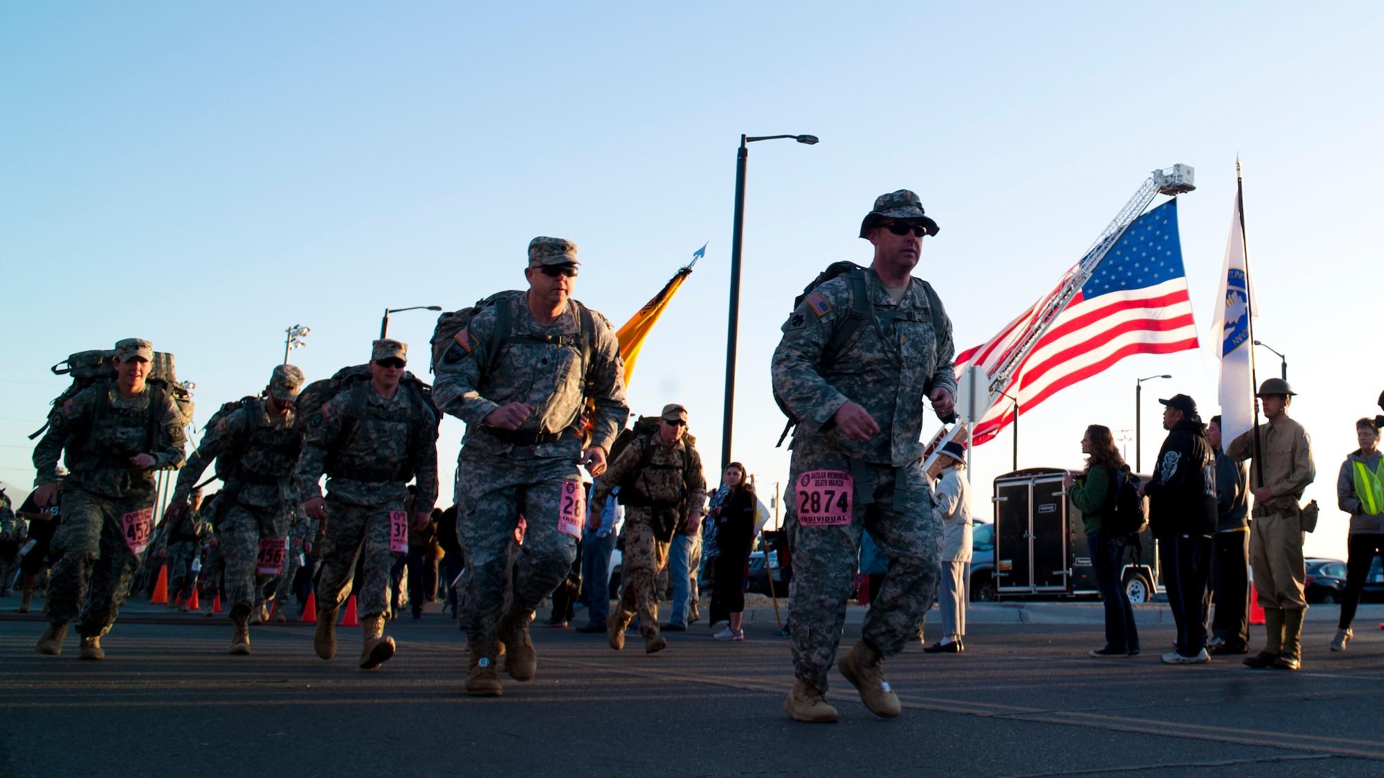 Participants depart from the start line as the Bataan Memorial Death March begins at White Sands Missile Range, N.M., March 23. Over 6,200 participants came to honor more than 76,000 Prisoners of War and Missing in Action from Bataan and Corregidor during World War II. The 26.2-mile course starts on WSMR, enters hilly terrain and finishes through sandy desert trails, with elevation ranging from 4,100 to 5,300 feet. (U.S. Air Force photo by Airman 1st Class Aaron Montoya / Released)