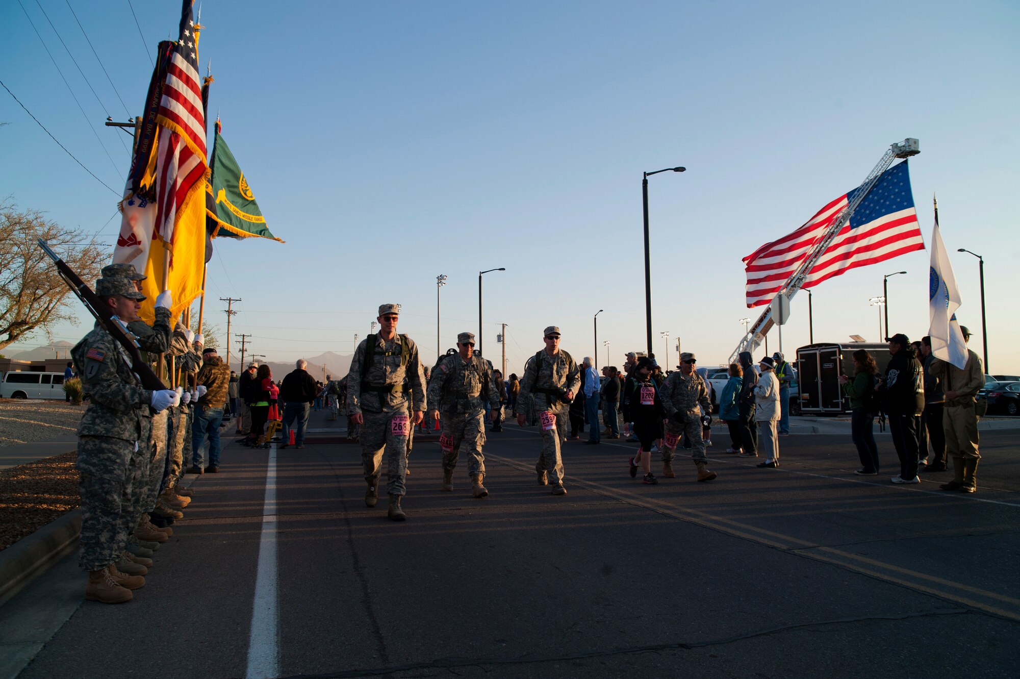 Participants depart from the start line as the Bataan Memorial Death March begins at White Sands Missile Range, N.M., March 23. Over 6,200 participants came to honor more than 76,000 Prisoners of War and Missing in Action from Bataan and Corregidor during World War II. The 26.2-mile course starts on WSMR, enters hilly terrain and finishes through sandy desert trails, with elevation ranging from 4,100 to 5,300 feet. (U.S. Air Force photo by Airman 1st Class Aaron Montoya / Released)