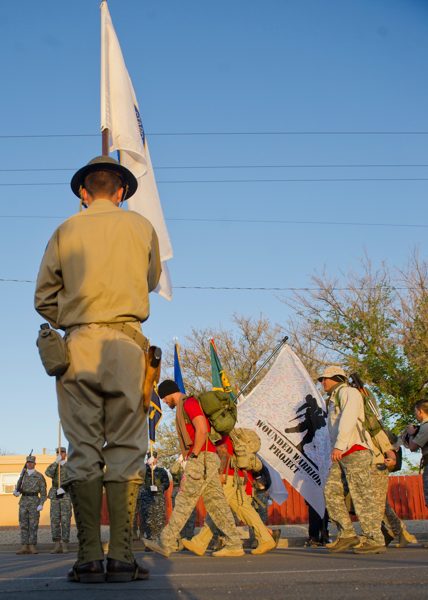 Members of the Wounded Warrior Project carry the flag representing their organization during the start of the Bataan Memorial Death March at White Sands Missile Range, N.M., March 23. Over 6,200 participants came to honor more than 76,000 Prisoners of War and Missing in Action from Bataan and Corregidor during World War II. The 26.2-mile course starts on WSMR, enters hilly terrain and finishes through sandy desert trails, with elevation ranging from 4,100 to 5,300 feet. (U.S. Air Force photo by Airman 1st Class Chase Cannon / Released)