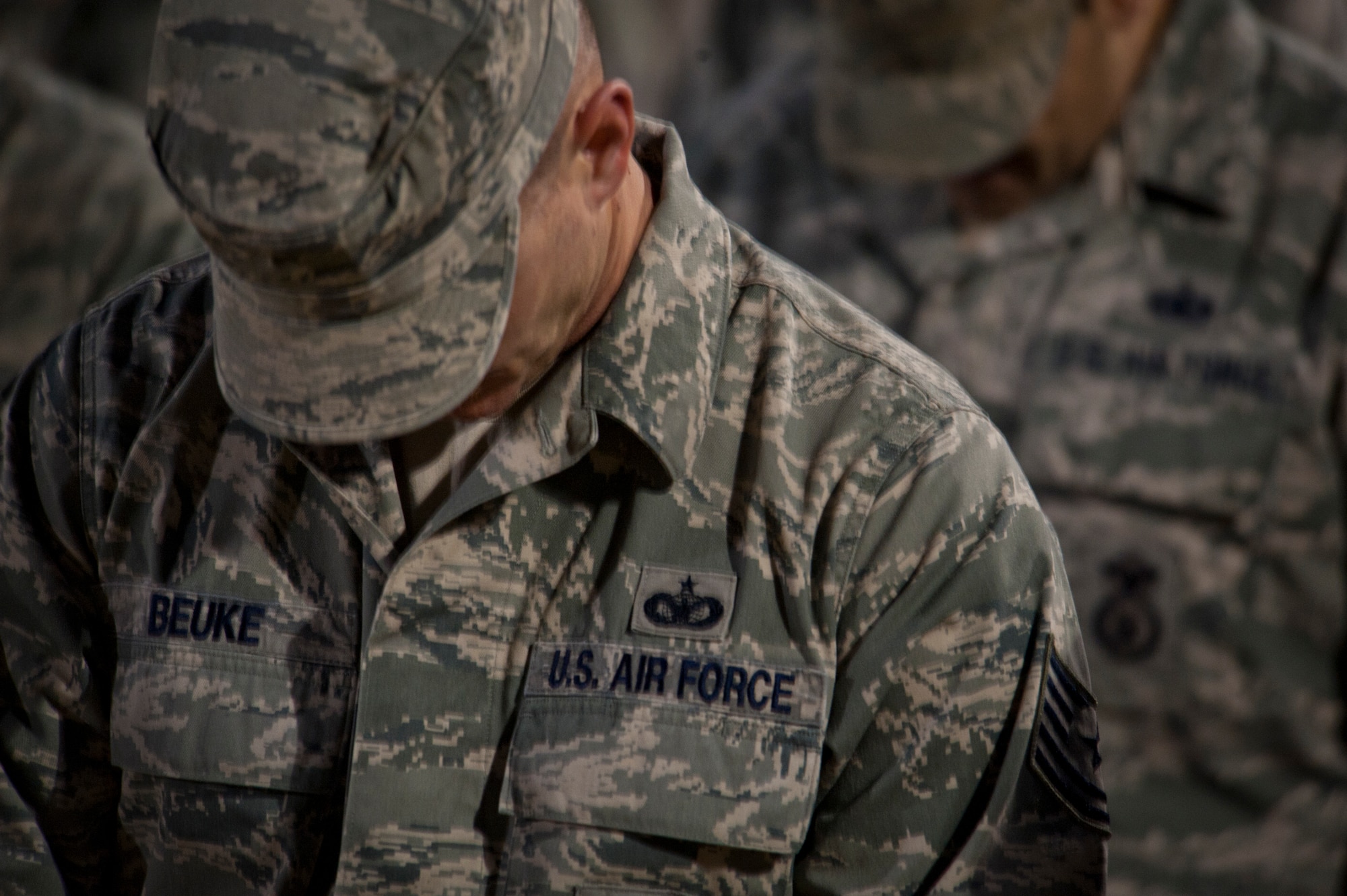 Participants in the Bataan Memorial Death March bow their heads while the invocation is given at White Sands Missile Range, N.M., March 23. Over 6,200 participants came to honor more than 76,000 Prisoners of War and Missing in Action from Bataan and Corregidor during World War II. The 26.2-mile course starts on WSMR, enters hilly terrain and finishes through sandy desert trails, with elevation ranging from 4,100 to 5,300 feet. (U.S. Air Force photo by Airman 1st Class Aaron Montoya / Released)