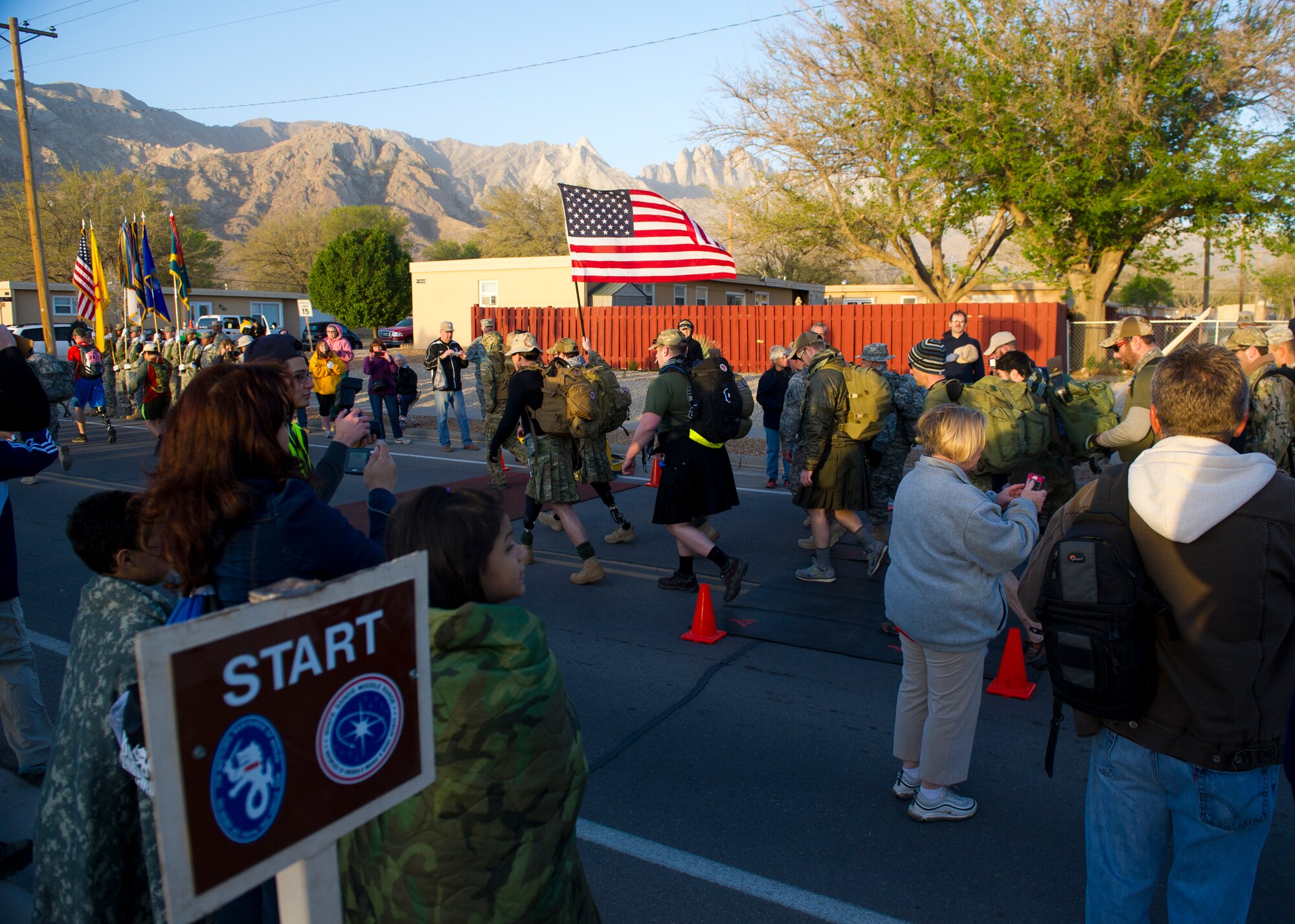 Members of the Wounded Warrior Project carry the United States flag during the start of the Bataan Memorial Death March at White Sands Missile Range, N.M., March 23. Over 6,200 participants came to honor more than 76,000 Prisoners of War and Missing in Action from Bataan and Corregidor during World War II. The 26.2-mile course starts on WSMR, enters hilly terrain and finishes through sandy desert trails, with elevation ranging from 4,100 to 5,300 feet. (U.S. Air Force photo by Airman 1st Class Chase Cannon / Released)