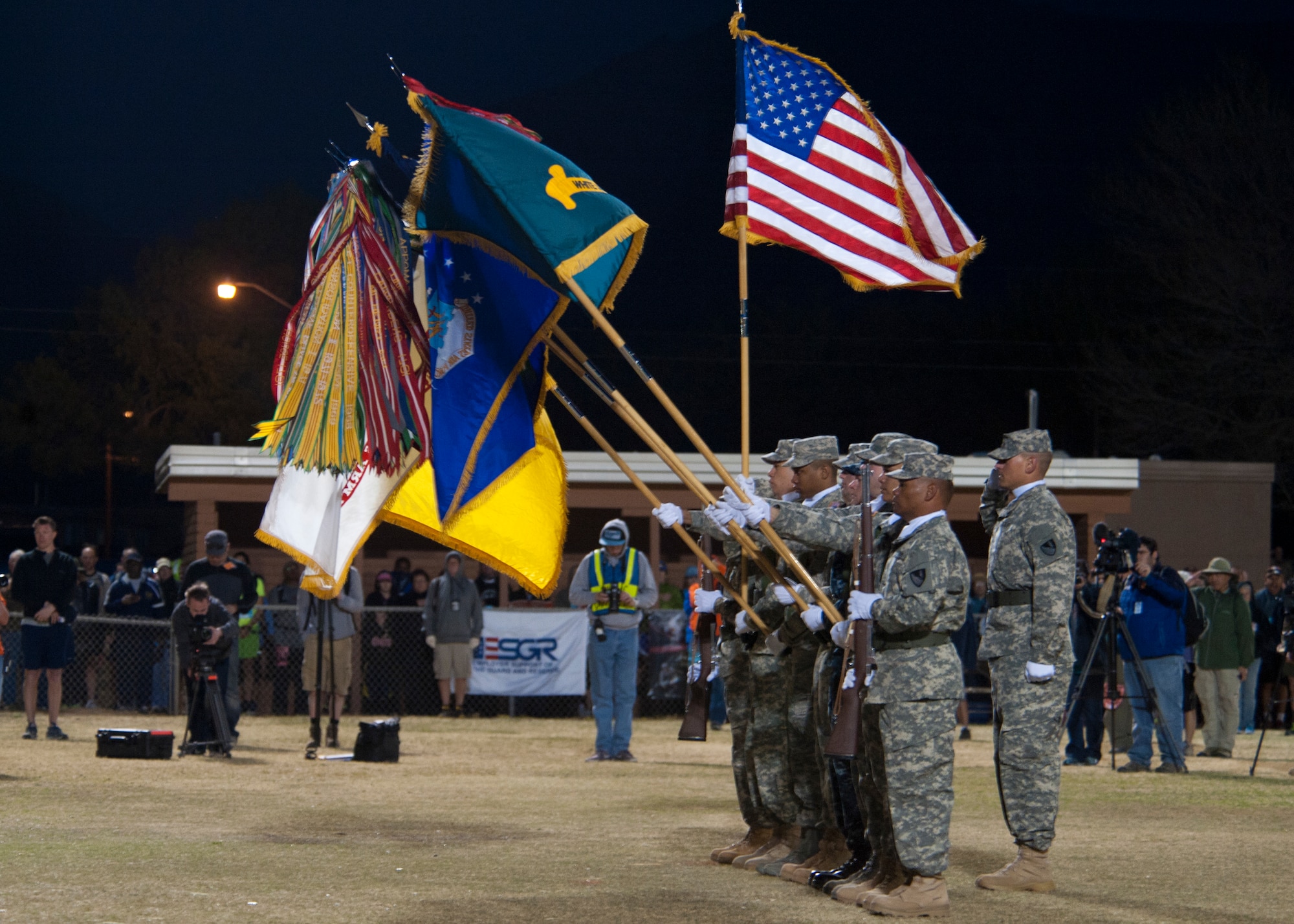 The White Sands Missile Range Honor Guard posts the colors during the opening ceremony on the 25th annual Bataan Memorial Death March at White Sands Missile Range, N.M., March 23. Over 6,200 participants came to honor more than 76,000 Prisoners of War and Missing in Action from Bataan and Corregidor during World War II. The 26.2-mile course starts on WSMR, enters hilly terrain and finishes through sandy desert trails, with elevation ranging from 4,100 to 5,300 feet. (U.S. Air Force photo by Airman 1st Class Aaron Montoya / Released)
