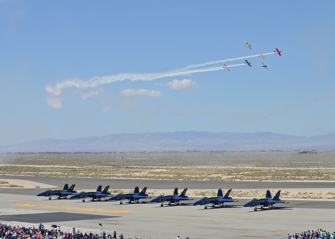 The West Coast Ravens perform a formation flight over the Blue Angels, the U.S. Navy Flight Demonstration Squadron, during the 2014 Los Angeles County Air Show on Mar. 21 at Fox Field. (U.S. Air Force photo by Jet Fabara)
