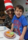 Four year old Easton Burley samples some green eggs and ham during a Dr. Seuss themed event done in conjunction with Read Across America in the Child Development Center at Ellsworth Air Force Base, S.D., March 4, 2014. During the day, Airmen and other volunteers took time to read to children in the CDC. (U.S. Air Force photo by Senior Airman Anania Tekurio/Released) 
