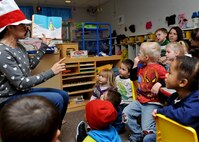 Eva Burley, wife of Master Sgt. Richard Burley, 37th Aircraft Maintenance Unit flight chief, reads Dr. Seuss stories to a group of children during an event done in conjunction with Read Across America in the Child Development Center at Ellsworth Air Force Base, S.D., March 4, 2014. Read Across America is an annual event designed to motivate children to read. (U.S. Air Force photo by Senior Airman Anania Tekurio/Released)