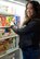 Yolanda Bottorf adds frozen dinners to one of the freezers in the Fisher House for Families of the Fallen, Dover Air Force Base, Del., March 24, 2014. Bottorf is the Families of the Fallen support manager for the USO. In her position with the USO, in addition to providing food for the Fisher House, she coordinates with USO staff to offer assistance to families traveling to Dover for a dignified transfer as well as to funerals and memorials. (U.S. Air Force photo/Roland Balik)