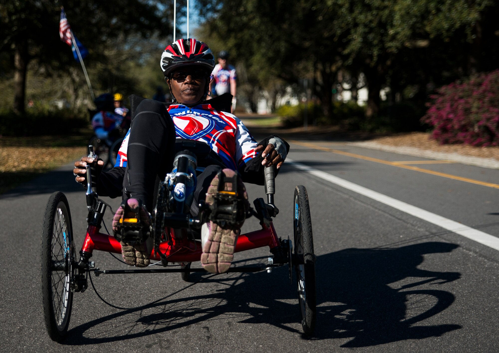 A Warrior Ride cyclist rides through Charleston, S.C., with a total of 45 riders behind her March 21, 2014. Warrior Ride is a non-profit organization that uses adaptive bicycling and other morale building events, such as kayaking and golf, as a tool for recreation and rehabilitation for our injured war heroes. (U.S. Air Force photo/ Senior Airman Dennis Sloan)