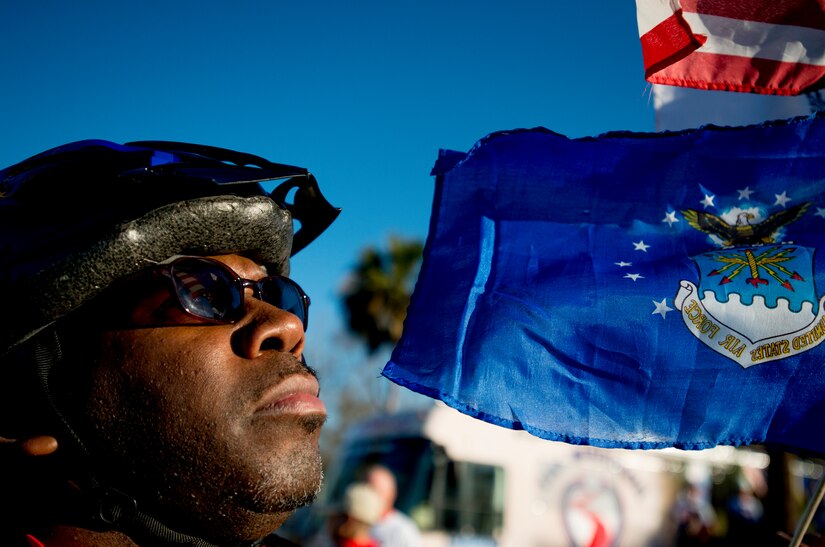 A Warrior Ride cyclist looks up at flags attached to his bike before the start of a ride through Charleston, S.C., March 21, 2014. Warrior Ride is a non-profit organization that uses adaptive bicycling and other morale building events, such as kayaking and golf, as a tool for recreation and rehabilitation for our injured war heroes. (U.S. Air Force photo/ Senior Airman Dennis Sloan)