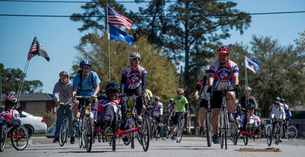 Members of the Warrior Ride cycle past the Joint Base Charleston Chapel March 21, 2014, on JB Charleston – Air Base, S.C. The Warrior Ride is a non-profit organization that uses adaptive bicycling and other morale building events, such as kayaking and golf, as a tool for recreation and rehabilitation for our injured war heroes. (U.S. Air Force photo/ Airman 1st Class Clayton Cupit)