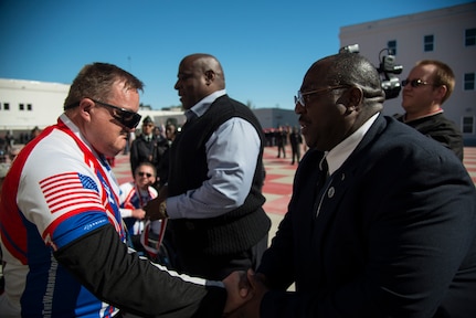 Ronald Mayfield, Warrior Ride cyclist, receives thanks from Anderson Townsend, Military Magnet Academy principal, after a welcoming ceremony March 21, 2014, at the Military Magnet Academy in North Charleston, S.C. The Warrior Ride made a stop at the Military Magnet Academy where the cadets conducted a pass in review for the riders. The Warrior Ride is a non-profit organization that uses adaptive bicycling and other morale building events, such as kayaking and golf, as a tool for recreation and rehabilitation for our injured war heroes. (U.S. Air Force photo/ Airman 1st Class Clayton Cupit)