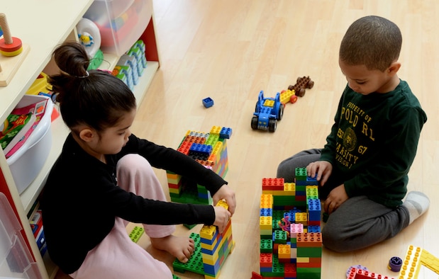 Alina Lipatan and Cameron Dunlap build Legos during Family Child Care, March 19, 2014, on Mountain Home Air Force Base, Idaho. The Air Force FCC provides an opportunity for spouses and dependents to become FCC providers. (U.S. Air Force photo by Caitlin Guinazu/RELEASED)