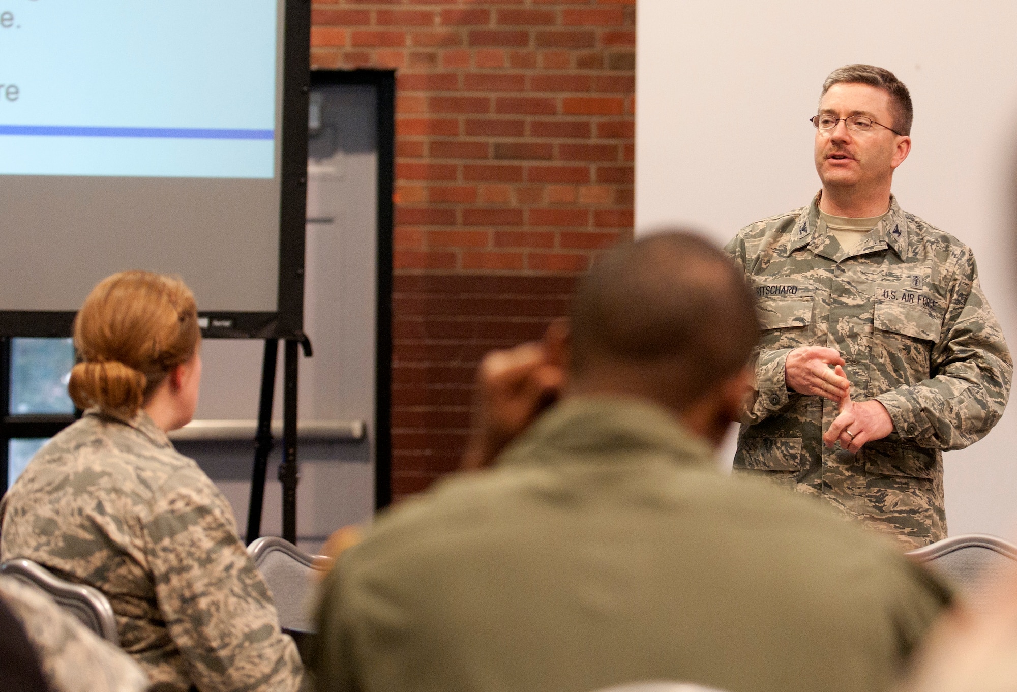 Col. Hans Ritschard, 90th Medical Group commander speaks about changes in the 90th MDG during a town hall meeting March 19, 2014, in the Fall Hall Community Center. (U.S. Air Force photo by Airman Malcolm Mayfield)