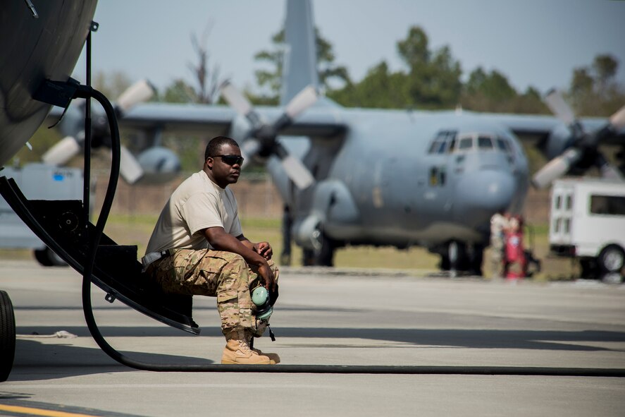 U.S. Air Force Staff Sgt. Andre Owens, 723d Aircraft Maintenance Squadron crew chief, takes a moment to himself outside HC-130P Combat King, tail number 65-0982, as HC-130P, tail number 64-4860, rests in the background March 21, 2014, at Moody Air Force Base, Ga. The aircraft are planned to be the final two active-duty HC-130Ps to deploy downrange as the Air Force transitions to the HC-130J Combat King II. (U.S. Air Force photo by Staff Sgt. Jamal D. Sutter/Released)