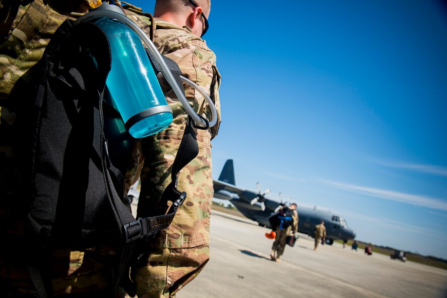 U.S. Air Force Senior Airman Erich Goen (left), 723d Aircraft Maintenance Squadron aerospace propulsion craftsman, makes his way to HC-130P Combat King, tail number 64-4860, March 21, 2014, at Moody Air Force Base, Ga. Goen departed with the aircraft to support operations in Air Forces Africa in what is planned to be the final deployment for active-duty HC-130Ps as the Air Force transitions to HC-130J Combat King IIs. (U.S. Air Force photo by Staff Sgt. Jamal D. Sutter/Released)