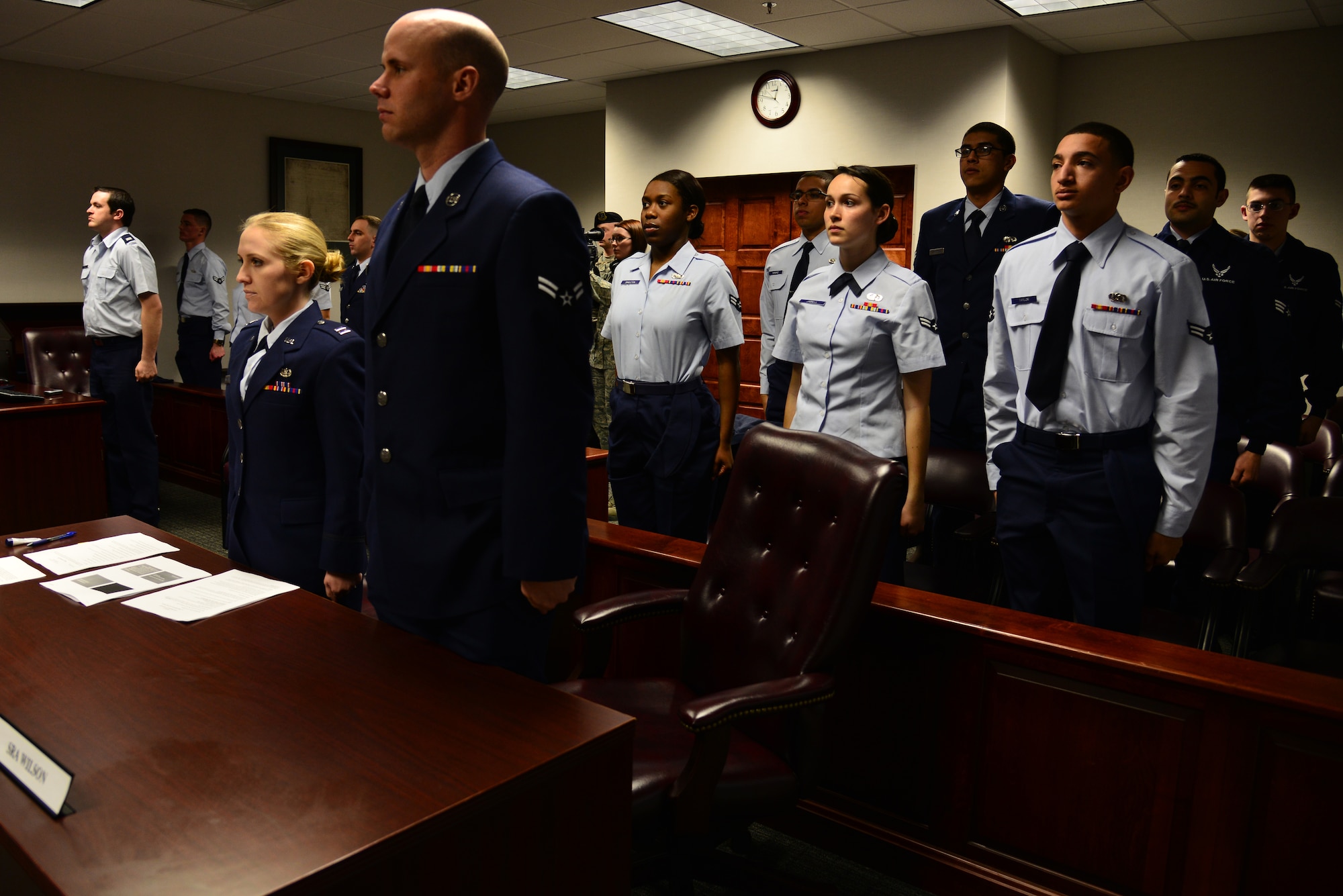 U.S. Air Force Airmen assigned to Joint Base Langley-Eustis, Va., stand as the judge enters the courtroom during a “Got Consent?” mock trial at Langley Air Force Base, Va., March 21, 2014. Airmen from the 633rd ABW legal office teamed with sexual assault response coordinators to teach junior enlisted Airmen about the consequences of sexual assault. (U.S. Air Force photo by Senior Airman Aubrey White/Released)
