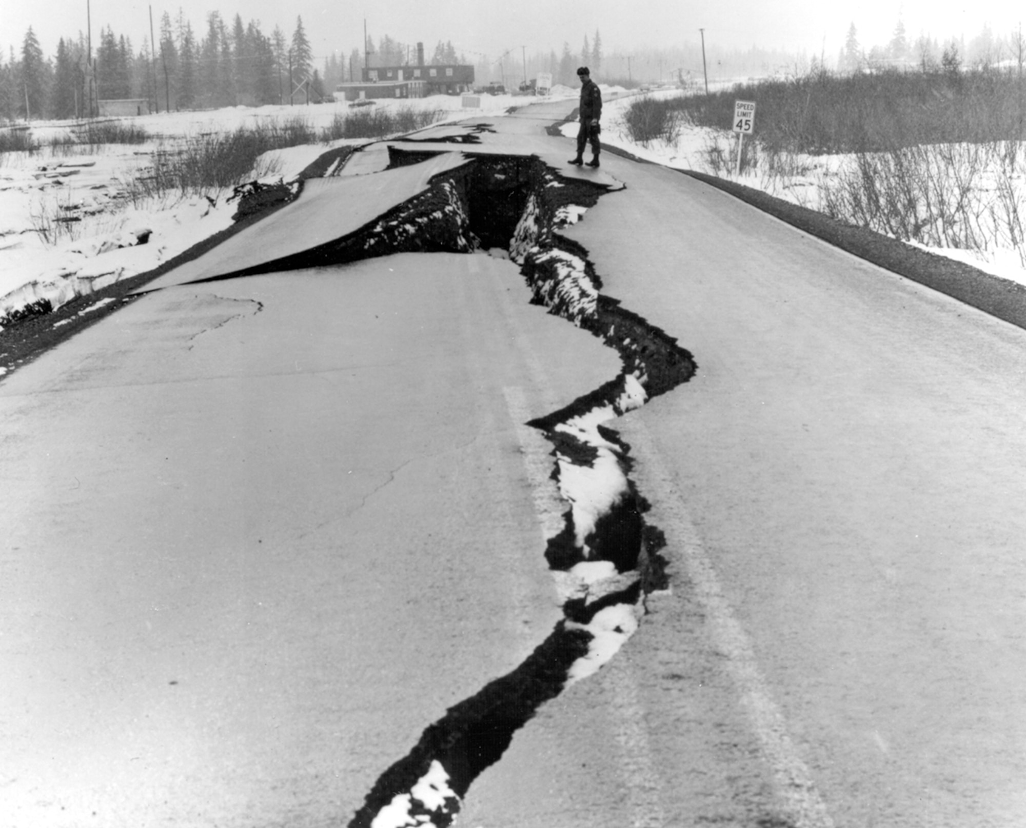Alaska Earthquake March 27, 1964. Fissures in Seward Highway near The Alaska Railroad station at Portage, at the head of Turnagain Arm. Many bridges were also damaged. At some places, tectonic subsidence and consolidation of alluvial materials dropped both highway and railroad below high-tide levels. (Photo by U.S. Army)