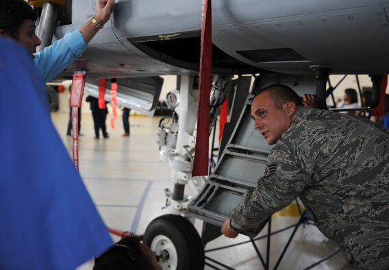 U.S. Air Force Staff Sgt. Brandon Dutton, 23d Equipment Maintenance Squadron armament weapons specialist, explains the parts of an A-10C Thunderbolt II to members of Leadership Georgia at Moody Air Force Base, Ga., March 21, 2014. The static displays were part of a visit by the members of Leadership Georgia. (U.S. Air Force photo by Senior Airman Olivia Bumpers/Released)
