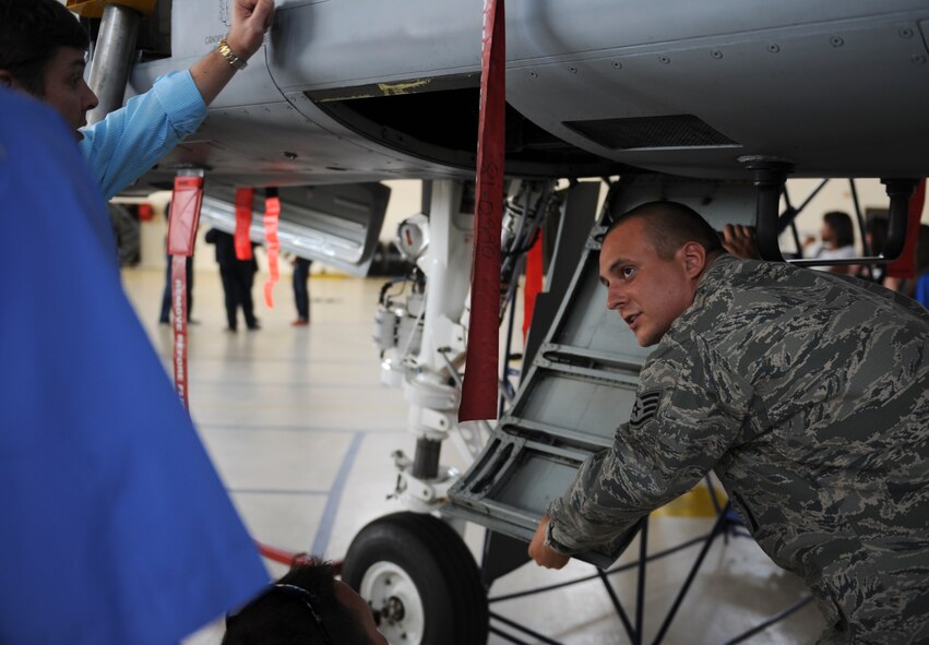 U.S. Air Force Staff Sgt. Brandon Dutton, 23d Equipment Maintenance Squadron armament weapons specialist, explains the parts of an A-10C Thunderbolt II to members of Leadership Georgia at Moody Air Force Base, Ga., March 21, 2014. The static displays were part of a visit by the members of Leadership Georgia. (U.S. Air Force photo by Senior Airman Olivia Bumpers/Released)